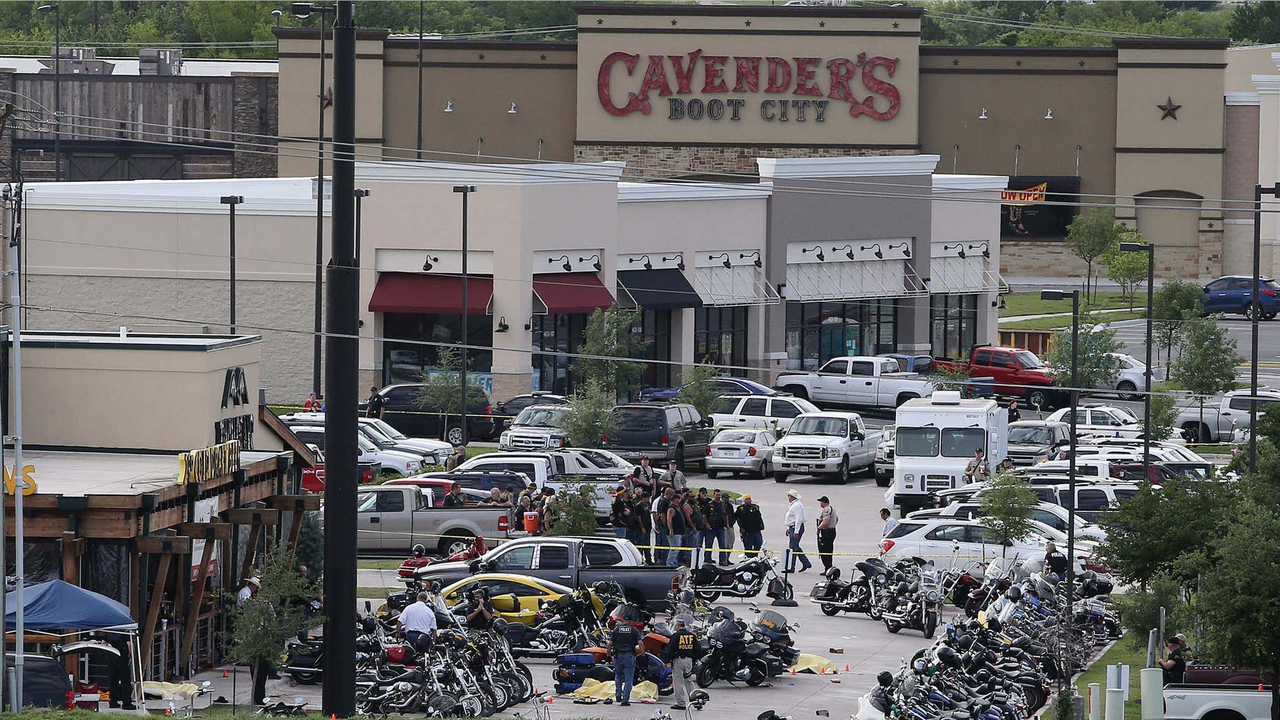 FILE - In this May 17, 2015, file photo, authorities investigate a shooting in the parking lot of Twin Peaks restaurant in Waco, Texas.