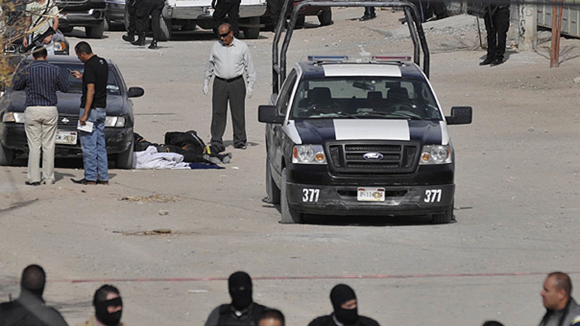 Dec. 4: Municipal and federal police secure the area after gunmen killed four municipal police officers in the northern border city of Ciudad Juarez.