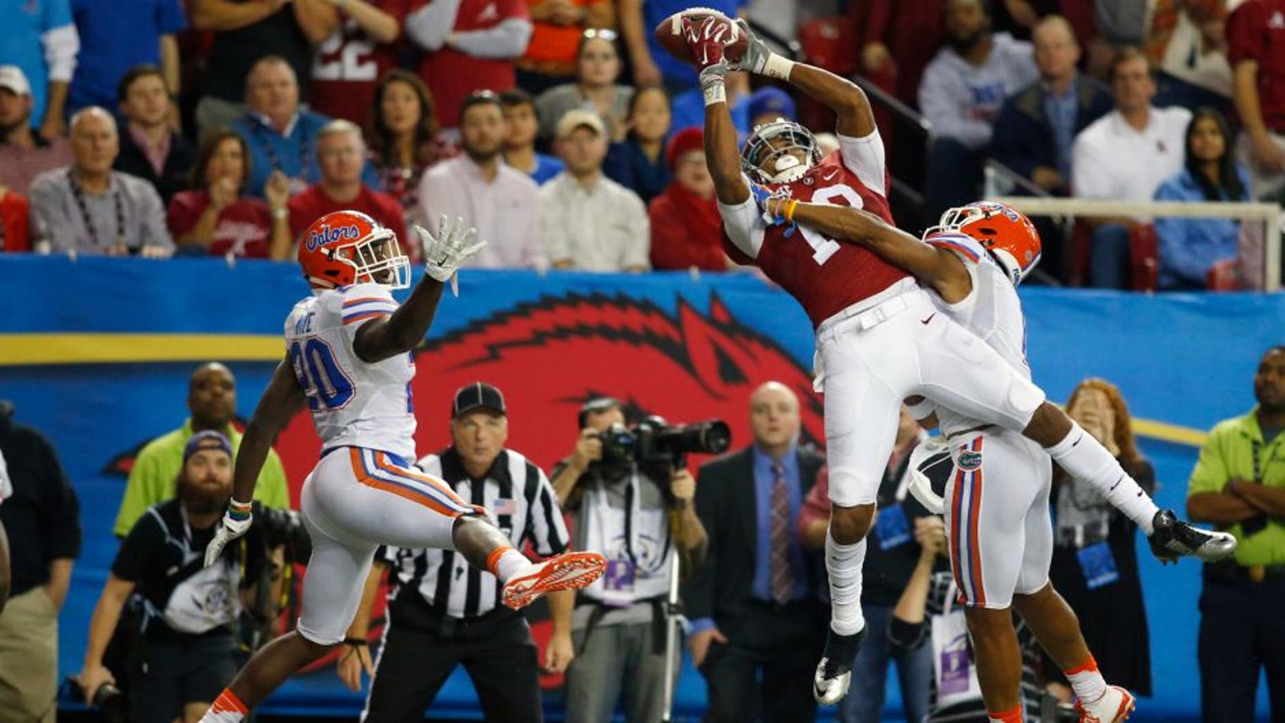 Dec 5, 2015; Atlanta, GA, USA; Alabama Crimson Tide wide receiver ArDarius Stewart (13) catches a 32 yard touchdown pass defended by Florida Gators defensive back Vernon Hargreaves III (1) and Marcus Maye (20) during the third quarter in the 2015 SEC Championship Game at the Georgia Dome. Mandatory Credit: Brett Davis-USA TODAY Sports