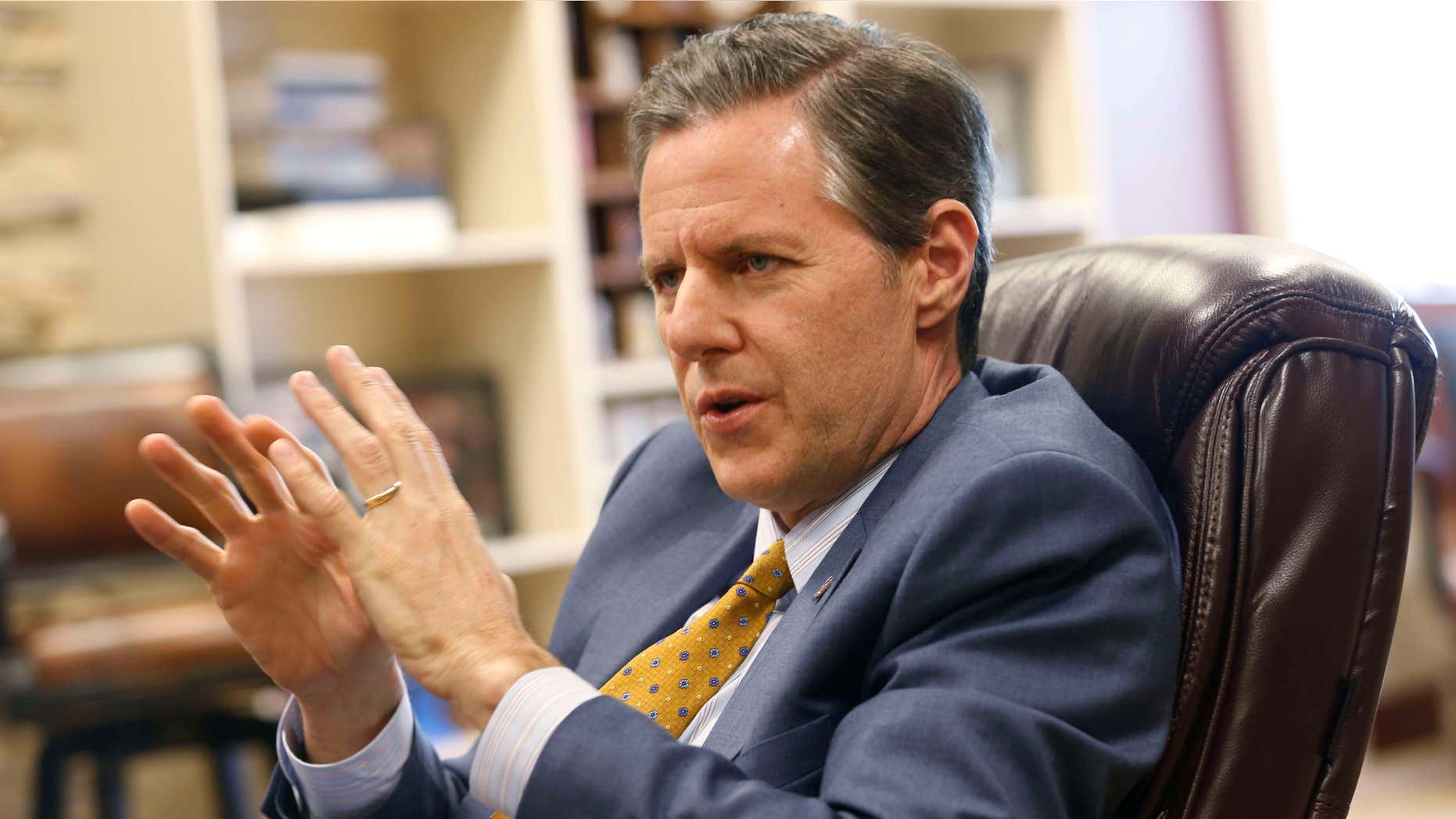FILE - In this April 21, 2015, file photo, Liberty University president, Jerry Falwell Jr., gestures during an interview at the school in Lynchburg, Va.
