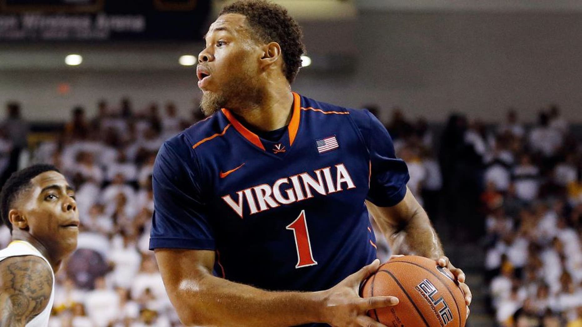 Dec 6, 2014; Richmond, VA, USA; Virginia Cavaliers guard Justin Anderson (1) looks to pass the ball as Virginia Commonwealth Rams guard/forward Terry Larrier (22) defends in the second half at Stuart Siegel Center. The Cavaliers won 74-57. Mandatory Credit: Geoff Burke-USA TODAY Sports