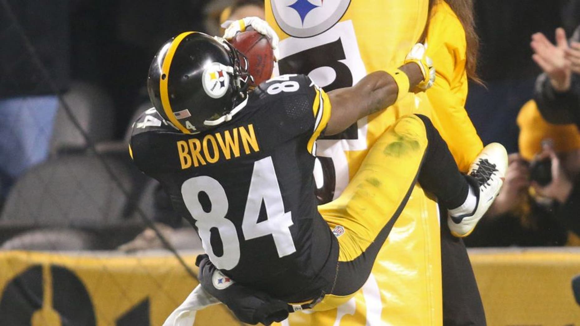 Dec 6, 2015; Pittsburgh, PA, USA; Pittsburgh Steelers wide receiver Antonio Brown (84) jumps onto the goal post padding after scoring on a seventy-one yard punt return for a touchdown against the Indianapolis Colts during the fourth quarter at Heinz Field. The Steelers won 45-10. Mandatory Credit: Charles LeClaire-USA TODAY Sports