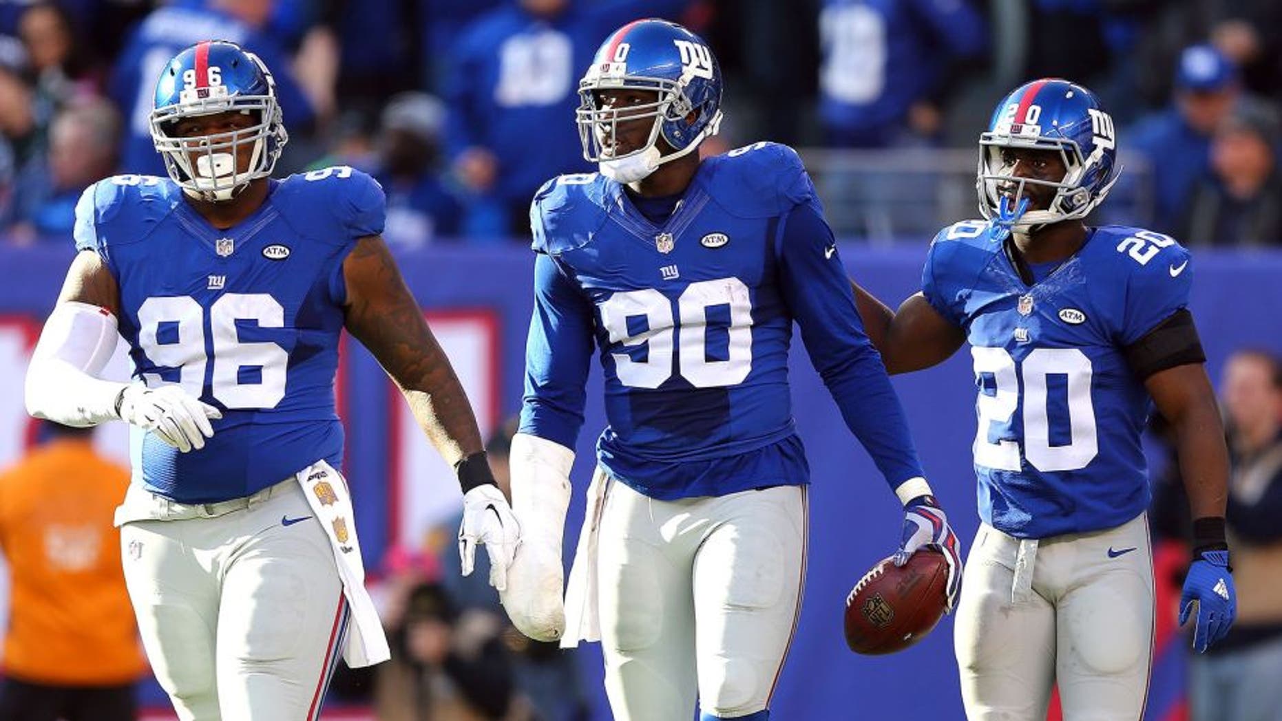 EAST RUTHERFORD, NJ - DECEMBER 06: Jason Pierre-Paul #90 of the New York Giants celebrates after recovering a fumble in the second quarter with Prince Amukamara #20 and Jay Bromley #96 against the New York Jets at MetLife Stadium on December 6, 2015 in East Rutherford, New Jersey. (Photo by Elsa/Getty Images)
