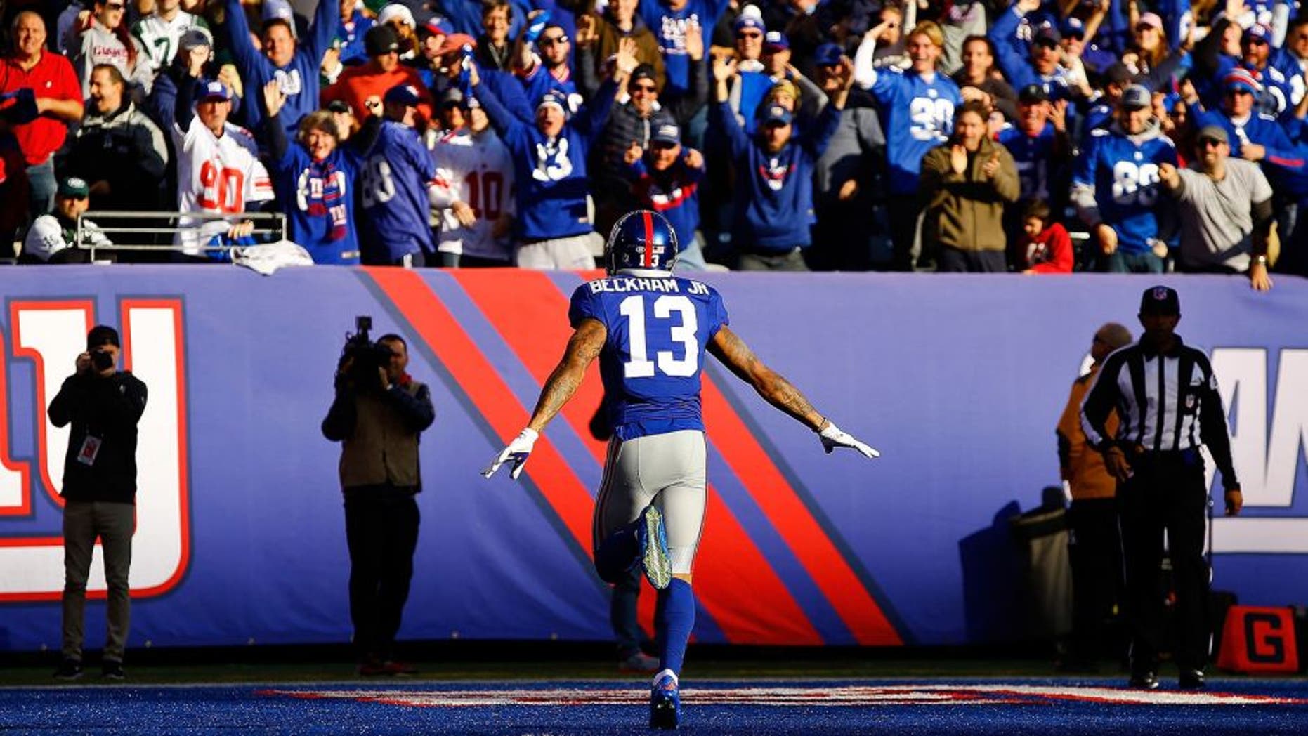EAST RUTHERFORD, NJ - DECEMBER 06: Odell Beckham Jr. #13 of the New York Giants celebrates after scoring a 72 yard long touchdown against the New York Jets at MetLife Stadium on December 6, 2015 in East Rutherford, New Jersey. (Photo by Al Bello/Getty Images)