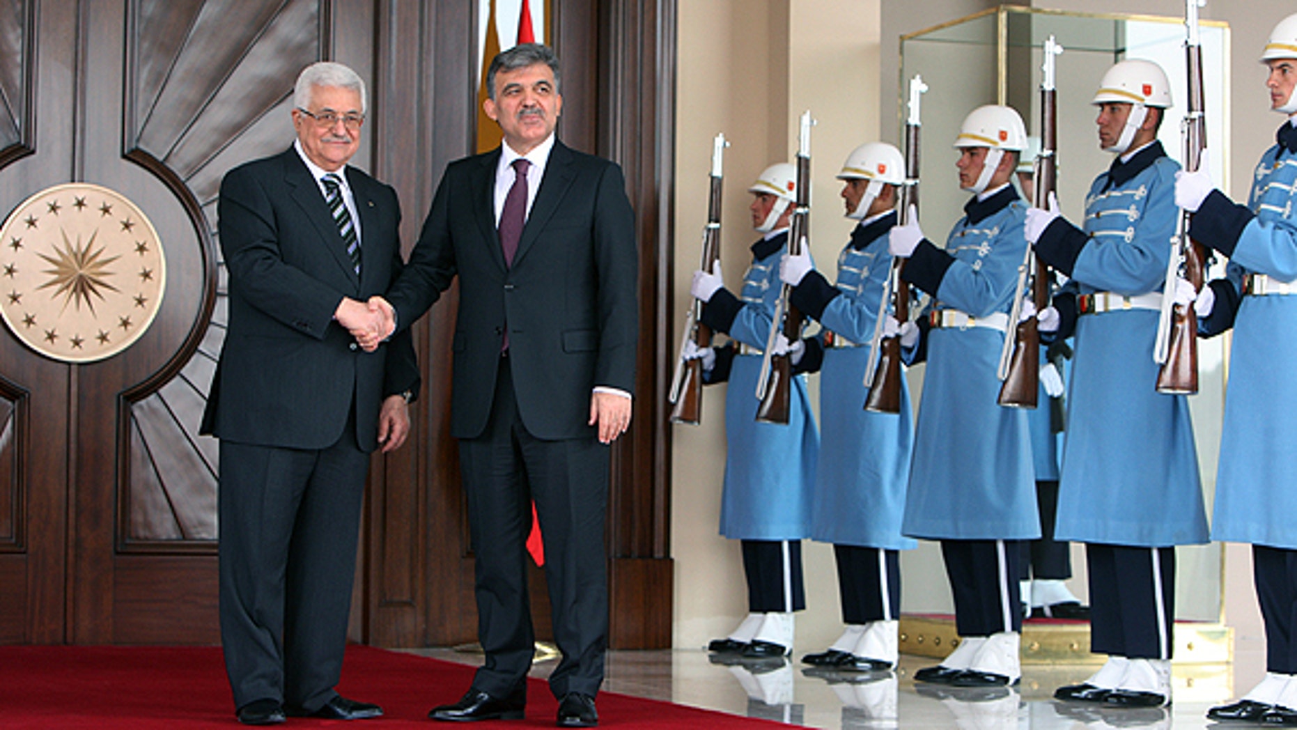 Palestinian leader Mahmoud Abbas, left, and Turkish President Abdullah Gul pose for media cameras before their meeting at the Cankaya Palace in Ankara, Turkey.