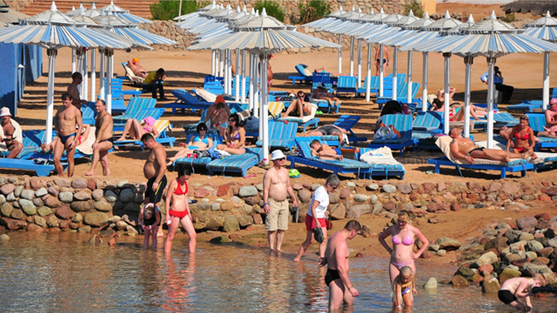 Dec. 6: Tourists sunbathe and stand in the shallow waters at the Egyptian Red Sea resort of Sharm el-Sheikh, Egypt.