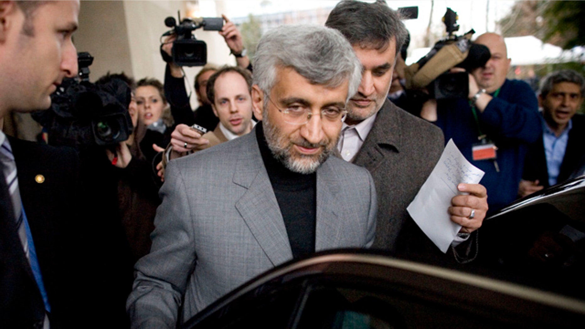 Dec. 7: Iran's chief negotiator Saeed Jalili, center, enters his car after a brief interview with Iranian Television in Geneva, Switzerland.
