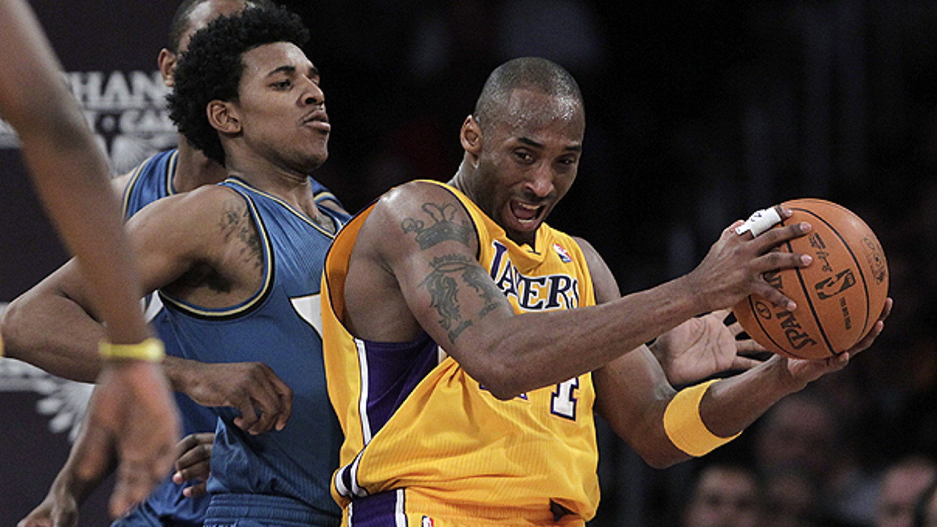 Dec. 7: Los Angeles Lakers guard Kobe Bryant, right, is pressured by Washington Wizards guard Nick Young during the first half of an NBA basketball game in Los Angeles.