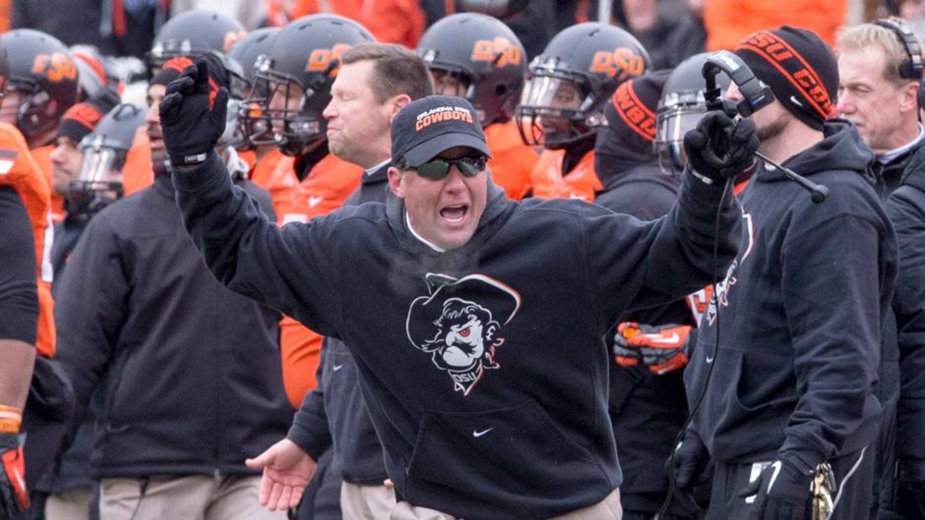 Dec 7, 2013; Stillwater, OK, USA; Oklahoma State Cowboys head coach Mike Gundy reacts to a call during the third quarter against the Oklahoma Sooners at Boone Pickens Stadium. Mandatory Credit: Richard Rowe-USA TODAY Sports