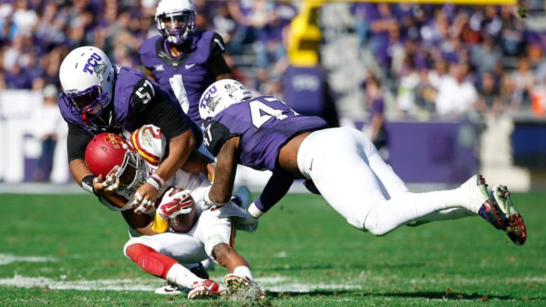 Dec 6, 2014; Fort Worth, TX, USA; TCU Horned Frogs defensive tackle Davion Pierson (57) and linebacker Paul Dawson (47) tackle Iowa State Cyclones running back Aaron Wimberly (2) during the game at Amon G. Carter Stadium. Mandatory Credit: Kevin Jairaj-USA TODAY Sports