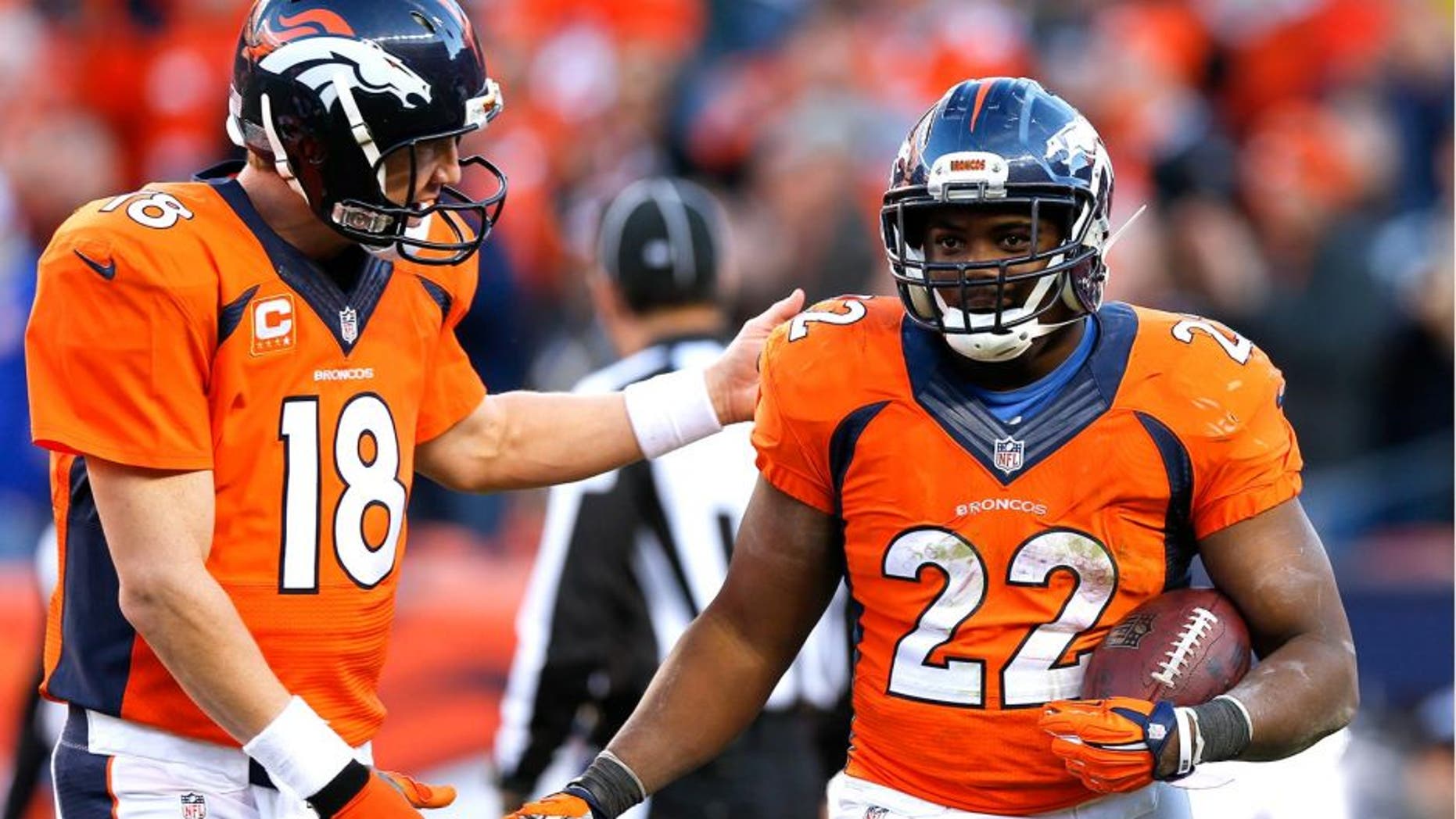 Denver Broncos running back C.J. Anderson, right, celebrates his touchdown with quarterback Peyton Manning during the second half in an NFL football game Sunday, Dec. 7, 2014, in Denver. (AP Photo/David Zalubowski)