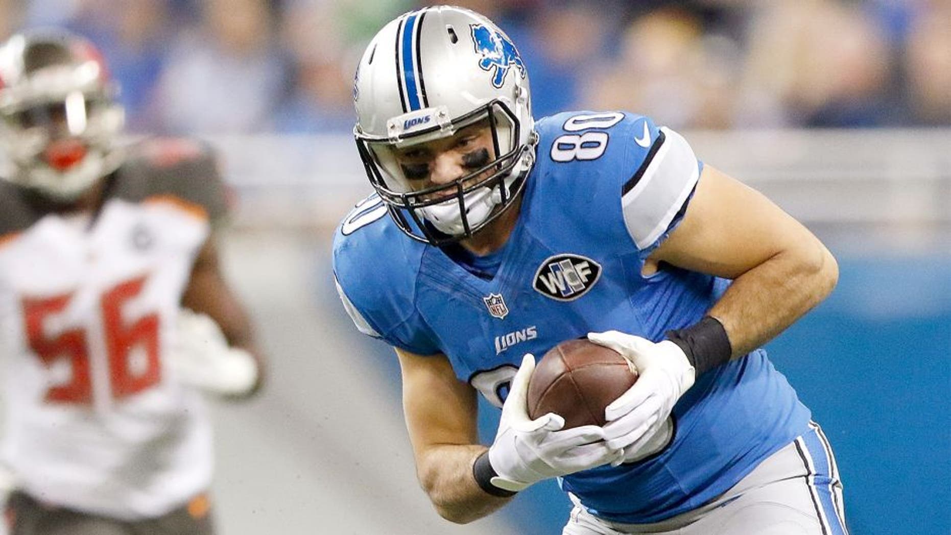 DETROIT, MI - DECEMBER 7: Joseph Fauria #80 of the Detroit Lions looks to gain yards in the first quarter while playing the Tampa Bay Buccaneers at Ford Field on December 7, 2014 in Detroit, Michigan. (Photo by Leon Halip/Getty Images)