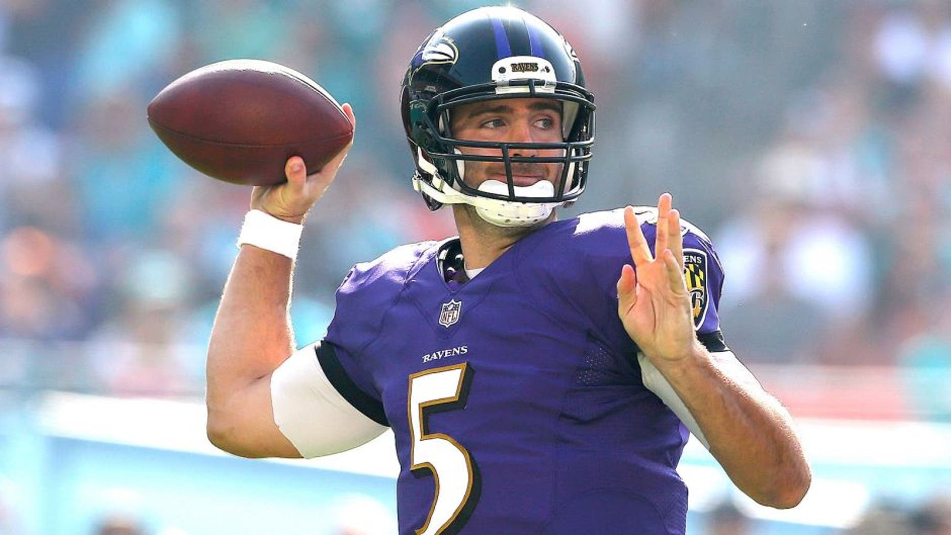 MIAMI GARDENS, FL - DECEMBER 07: Quarterback Joe Flacco #5 of the Baltimore Ravens throws against the Miami Dolphins in the second quarter during a game at Sun Life Stadium on December 7, 2014 in Miami Gardens, Florida. (Photo by Mike Ehrmann/Getty Images)