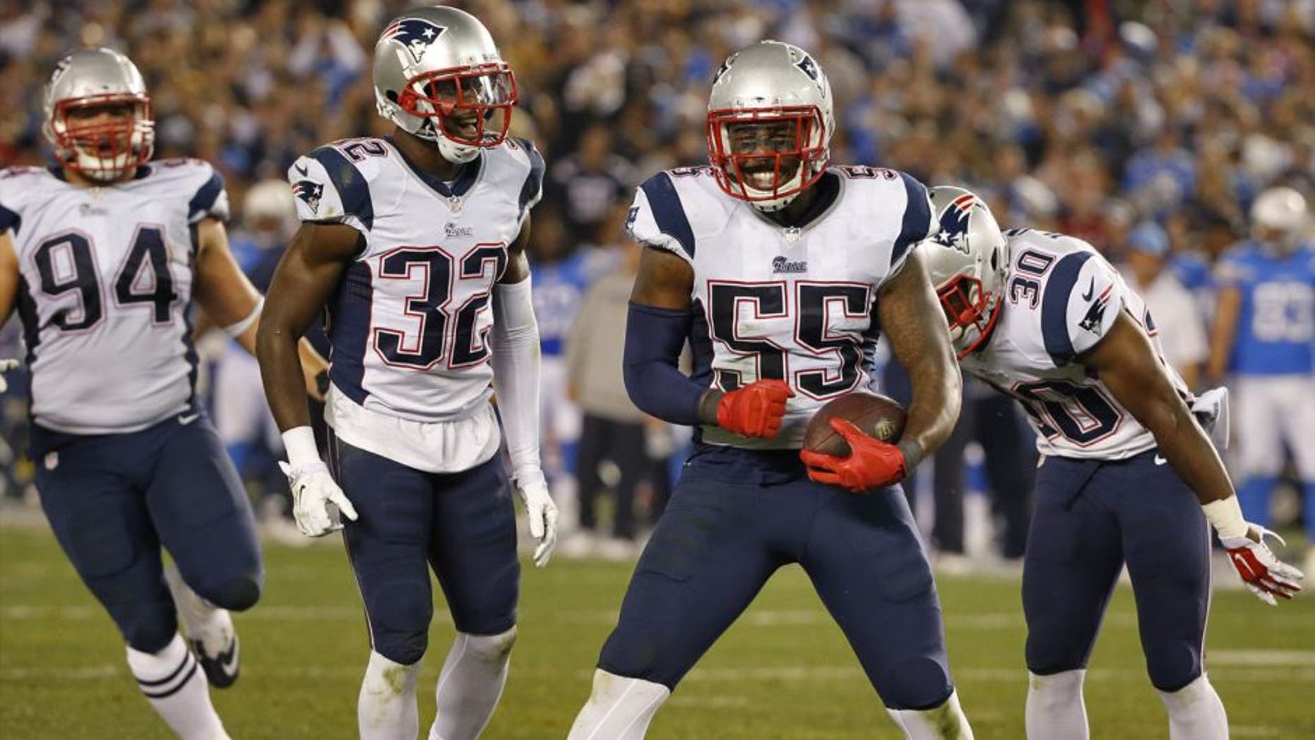 New England Patriots outside linebacker Akeem Ayers (55) celebrates his interception against the San Diego Chargers during the second half in an NFL football game Sunday, Dec. 7, 2014, in San Diego. (AP Photo/Lenny Ignelzi)