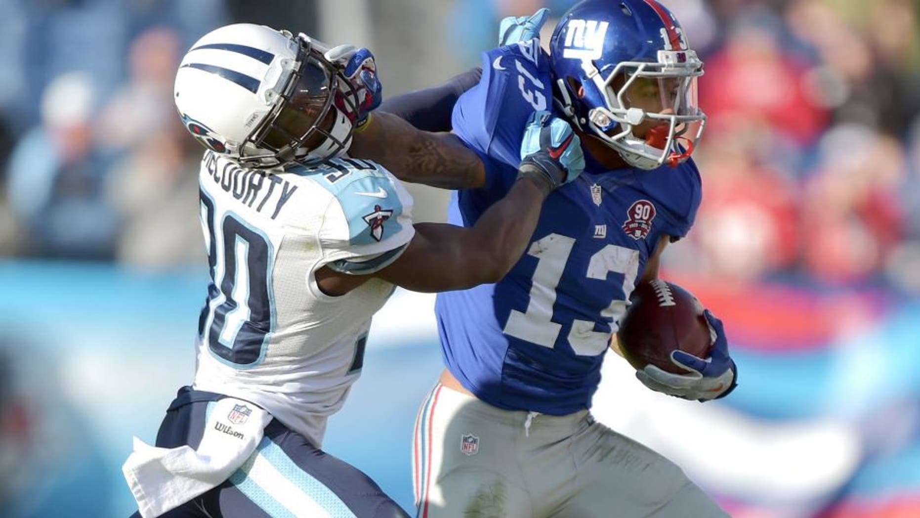 Dec 7, 2014; Nashville, TN, USA; New York Giants wide receiver Odell Beckham Jr (13) carries the ball against Tennessee Titans cornerback Jason McCourty (30) during the second half at LP Field. The Giants beat the Titans 36-7. Mandatory Credit: Don McPeak-USA TODAY Sports
