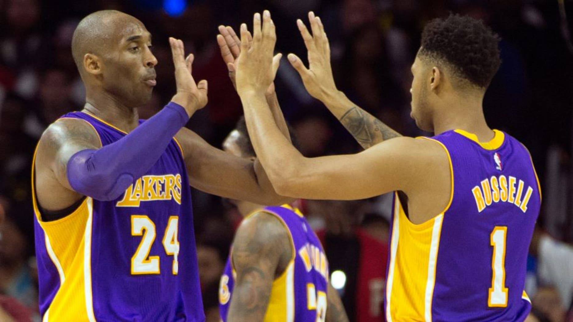 PHILADELPHIA, PA - DECEMBER 1: Kobe Bryant #24 and D'Angelo Russell #1 of the Los Angeles Lakers react in the game against the Philadelphia 76ers on December 1, 2015 at the Wells Fargo Center in Philadelphia, Pennsylvania. NOTE TO USER: User expressly acknowledges and agrees that, by downloading and or using this photograph, User is consenting to the terms and conditions of the Getty Images License Agreement. (Photo by Mitchell Leff/Getty Images)