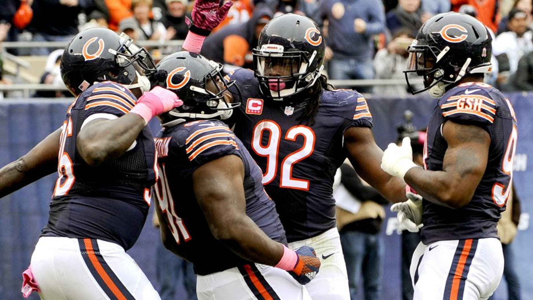 Oct 4, 2015; Chicago, IL, USA; Chicago Bears nose tackle Eddie Goldman (91) celebrates with Chicago Bears defensive end Jarvis Jenkins (96), Chicago Bears outside linebacker Pernell McPhee (92) and Chicago Bears linebacker Lamarr Houston (99) after he sacked Oakland Raiders quarterback Derek Carr (4) in the first half at Soldier Field. Mandatory Credit: Matt Marton-USA TODAY Sports