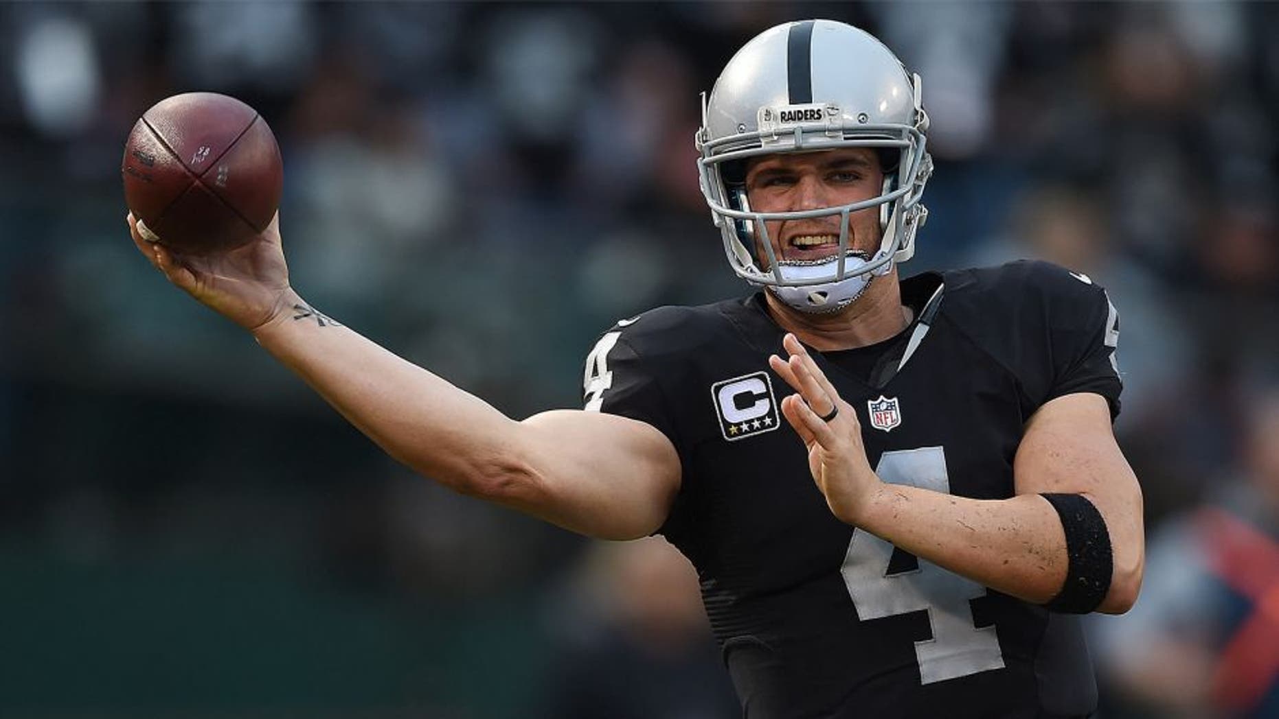 OAKLAND, CA - DECEMBER 06: Derek Carr #4 of the Oakland Raiders looks to throw a pass against the Kansas City Chiefs during their NFL football game at O.co Coliseum on December 6, 2015 in Oakland, California. (Photo by Thearon W. Henderson/Getty Images)