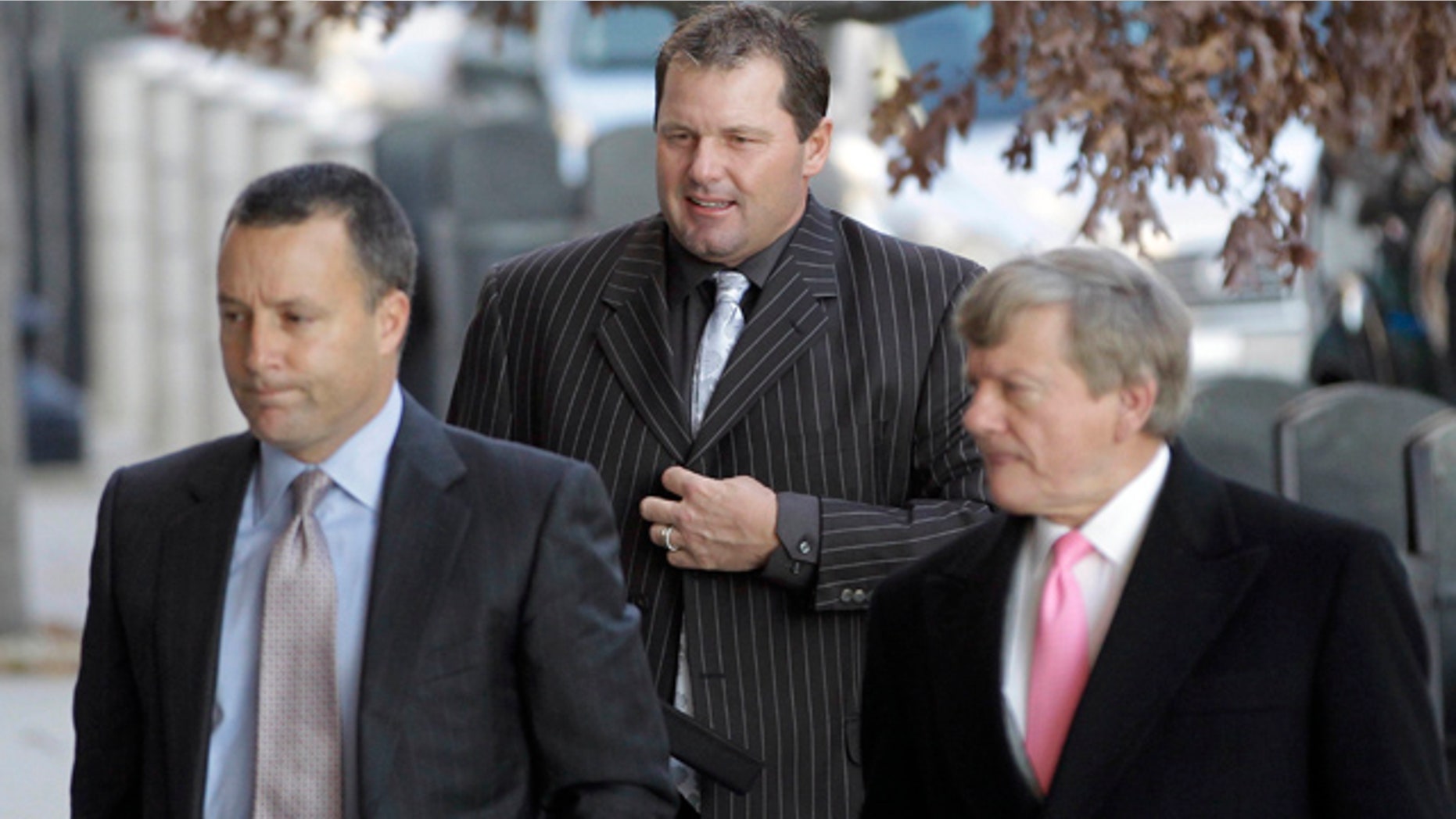 Dec. 8: Former Major League Baseball pitcher Roger Clemens, center, accompanied by his lawyers, Michael Attanasio, left, and Rusty Hardin, arrives at court in Washington for an interim status conference on charges he lied to Congress when he denied taking steroids or other performance enhancing drugs.