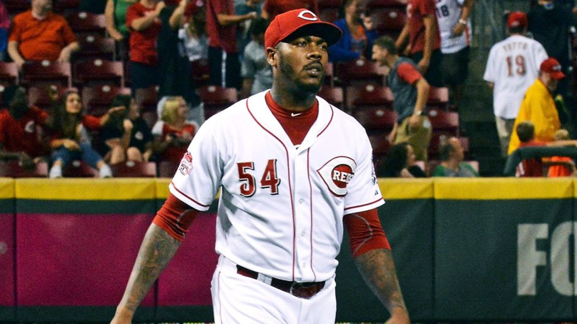 CINCINNATI, OH - SEPTEMBER 25: Aroldis Chapman #54 of the Cincinnati Reds walks to the mound to pitch in the ninth inning against the New York Mets with an image of his face on the scoreboard behind him at Great American Ball Park on September 25, 2015 in Cincinnati, Ohio. New York defeated Cincinnati 12-5. (Photo by Jamie Sabau/Getty Images)