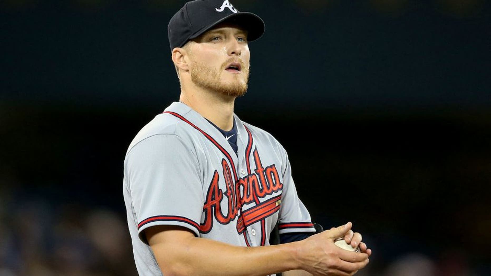 TORONTO, CANADA - APRIL 19: Shelby Miller #17 of the Atlanta Braves rubs up a baseball in the sixth inning during MLB game action against the Toronto Blue Jays on April 19, 2015 at Rogers Centre in Toronto, Ontario, Canada. (Photo by Tom Szczerbowski/Getty Images)