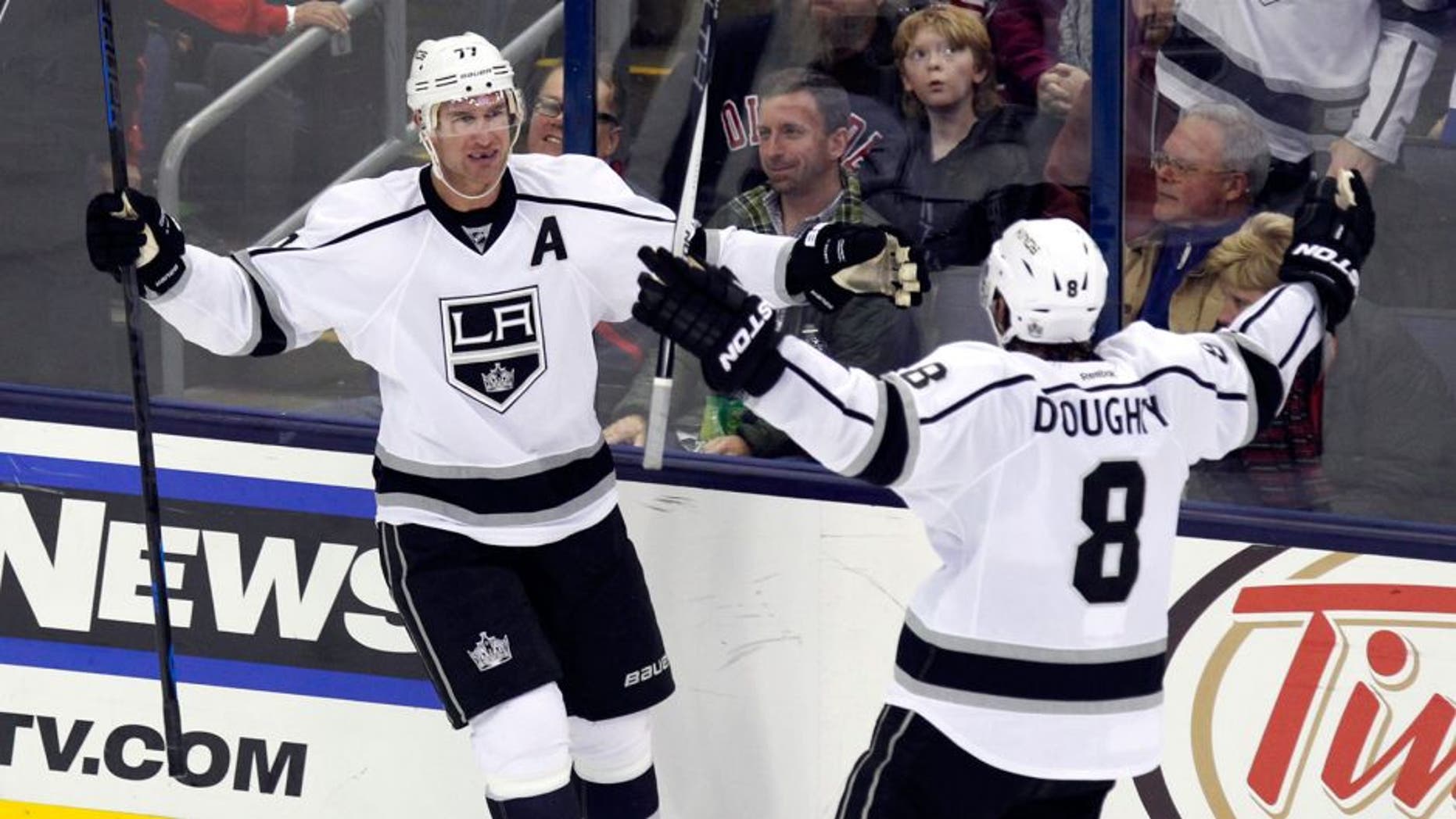 Los Angeles Kings' Jeff Carter, left, celebrates his goal against the Columbus Blue Jackets with teammate Drew Doughty during the third period of an NHL hockey game in Columbus, Ohio, Tuesday, Dec. 8, 2015. Los Angeles won 3-2 in overtime. (AP Photo/Paul Vernon)