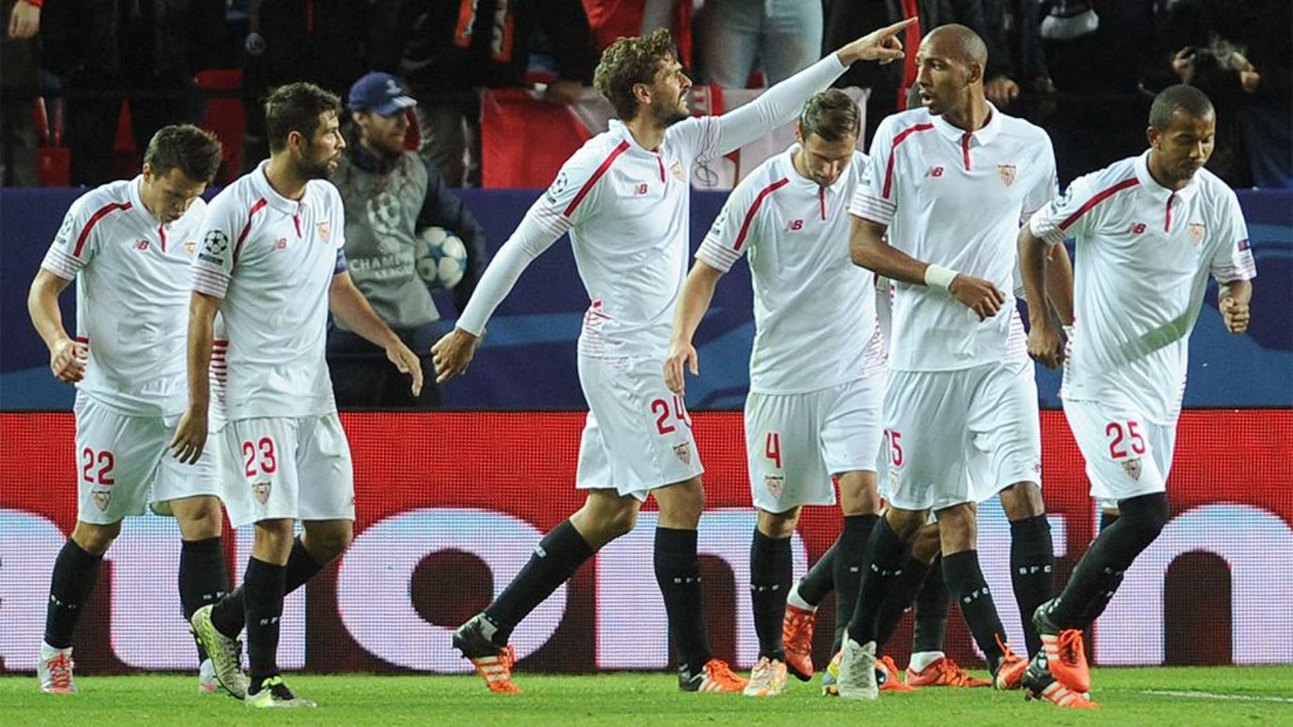 Sevilla's Spanish forward Fernando Llorente (C) celebrates with teammates after scoring a goal during the UEFA Champions League Group D football match Sevilla FC vs Juventus at the Ramon Sanchez Pizjuan stadium in Sevilla on December 8, 2015. AFP PHOTO/ CRISTINA QUICLER / AFP / CRISTINA QUICLER (Photo credit should read CRISTINA QUICLER/AFP/Getty Images)