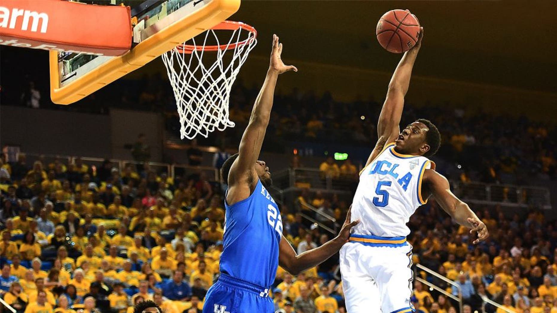 LOS ANGELES, CA - DECEMBER 03: Prince Ali #5 of the UCLA Bruins dunks over Alex Poythress #22 of the Kentucky Wildcats during an 87-77 UCLA win at Pauley Pavilion on December 3, 2015 in Los Angeles, California. (Photo by Harry How/Getty Images)