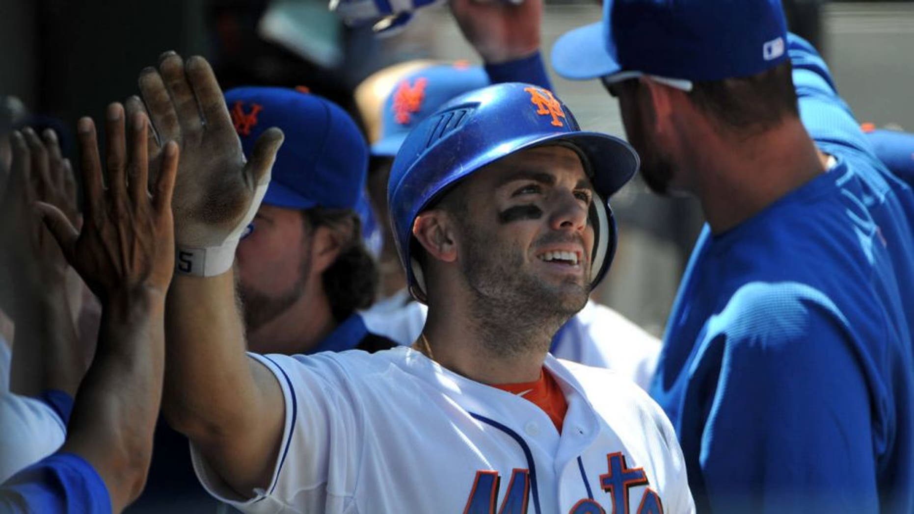 NEW YORK, NY - AUGUST 11: David Wright #5 of the New York Mets is congratulated after scoring on a double by Lucas Duda #21 of the New York Mets (not pictured) in the bottom of the third inning against the San Diego Padres at Citi Field on August 11, 2011 in the Flushing neighborhood of the Queens borough of New York City. (Photo by Christopher Pasatieri/Getty Images)