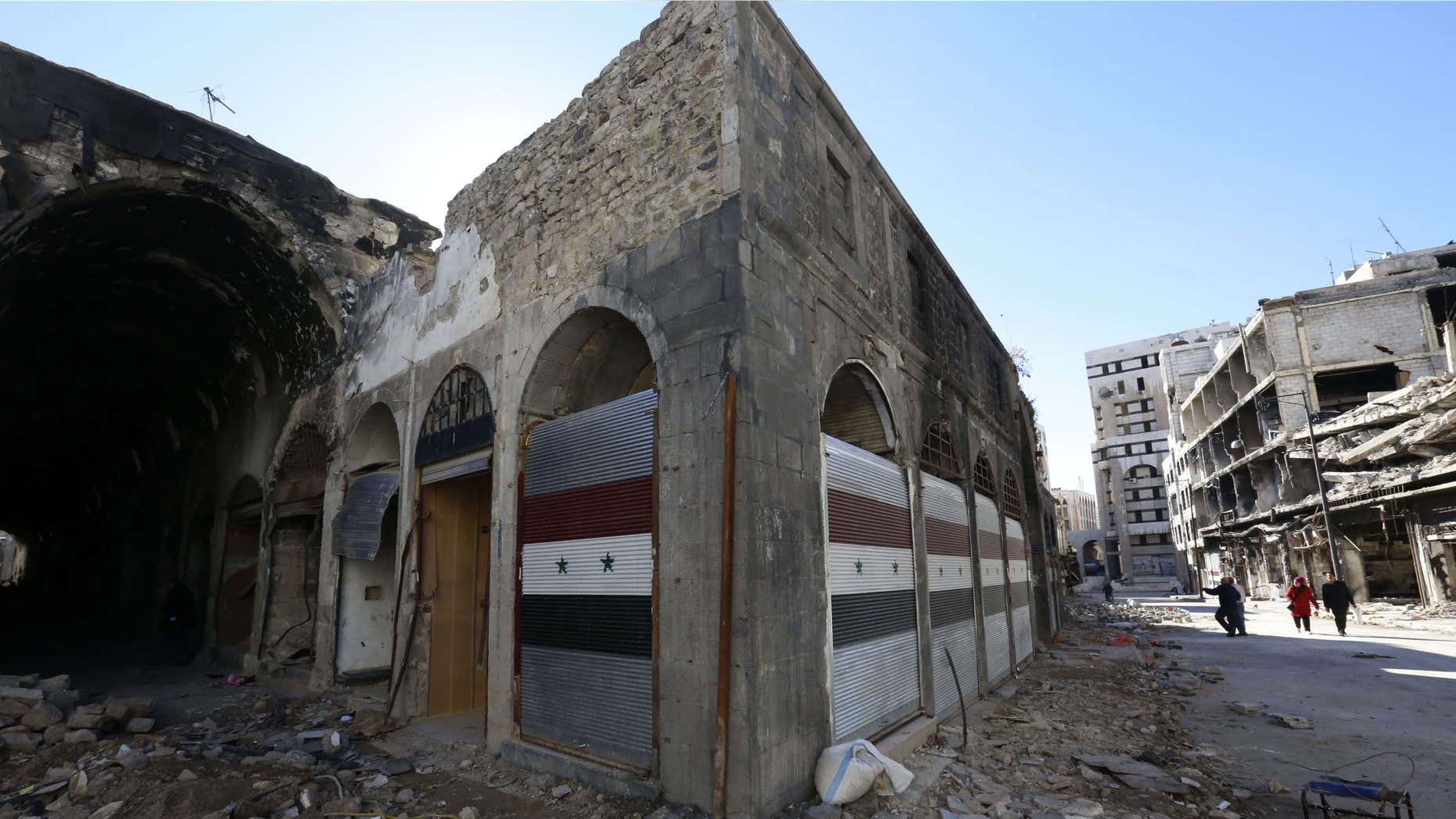 Dec. 9, 2015: Damaged shops are seen with new doors in the old city of Homs, Syria.