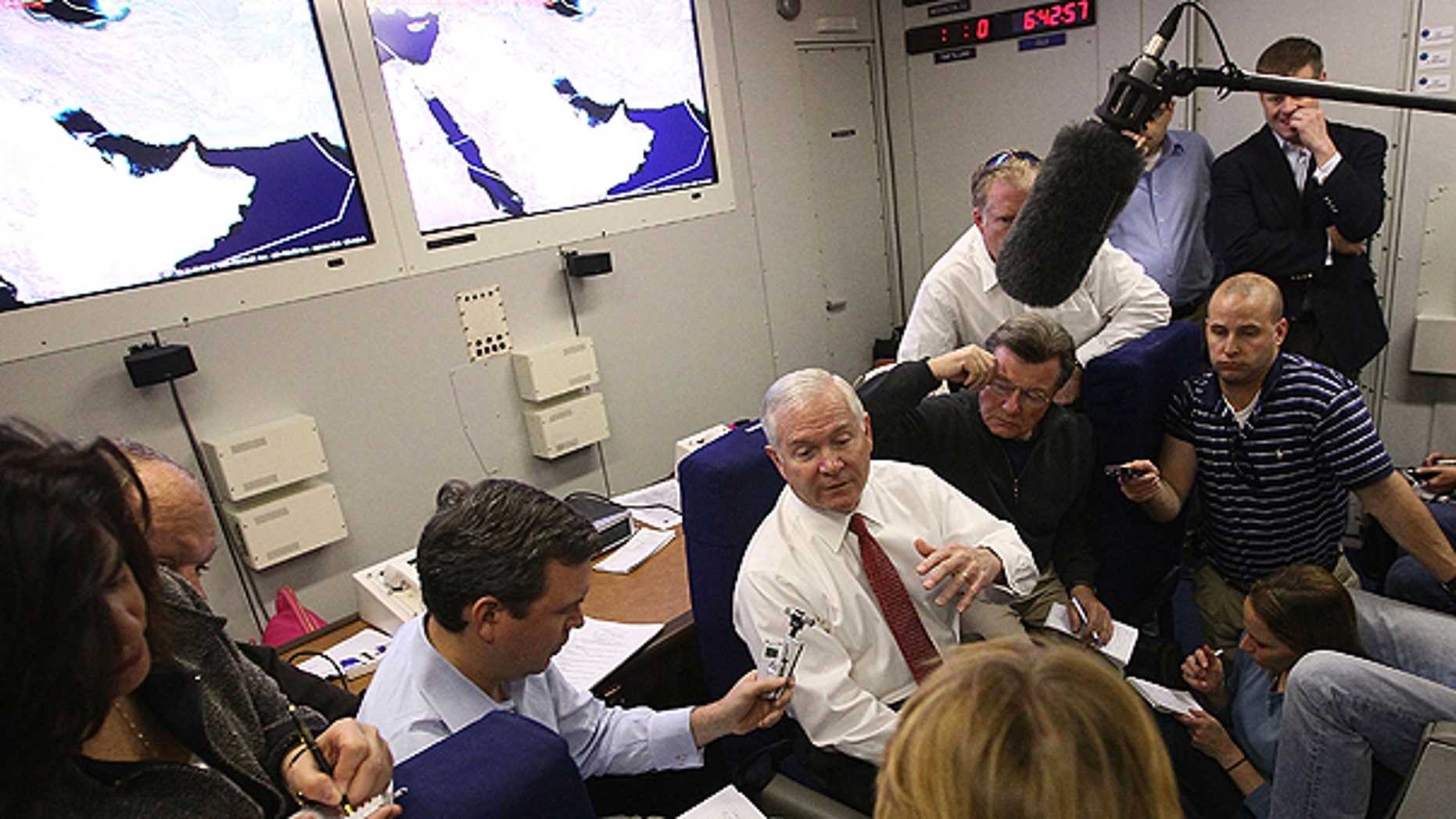 Dec. 10: U.S. Secretary of Defense Robert Gates answers questions from reporters on board his plane returning to the United States shortly after departing from Abu Dhabi.