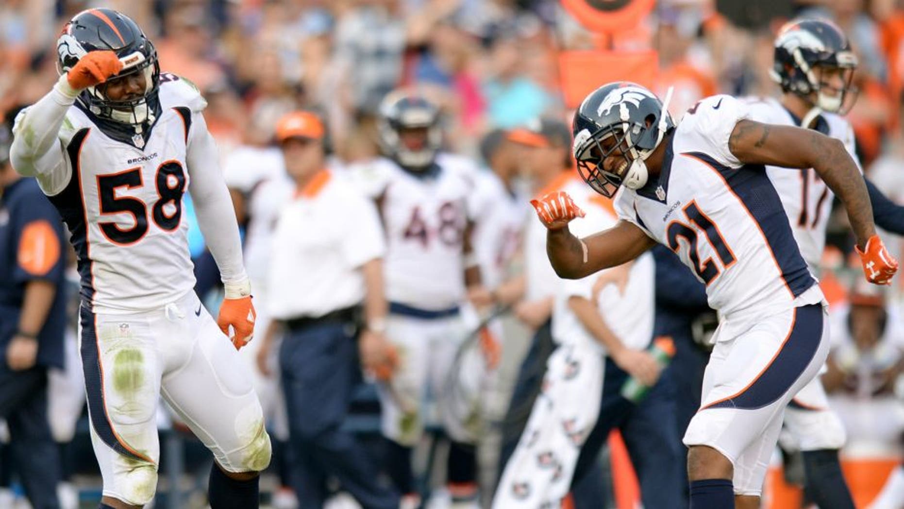 Dec 6, 2015; San Diego, CA, USA; Denver Broncos outside linebacker Von Miller (58) and cornerback Aqib Talib (21) celebrate after a defensive stop during the fourth quarter against the San Diego Chargers at Qualcomm Stadium. Mandatory Credit: Jake Roth-USA TODAY Sports