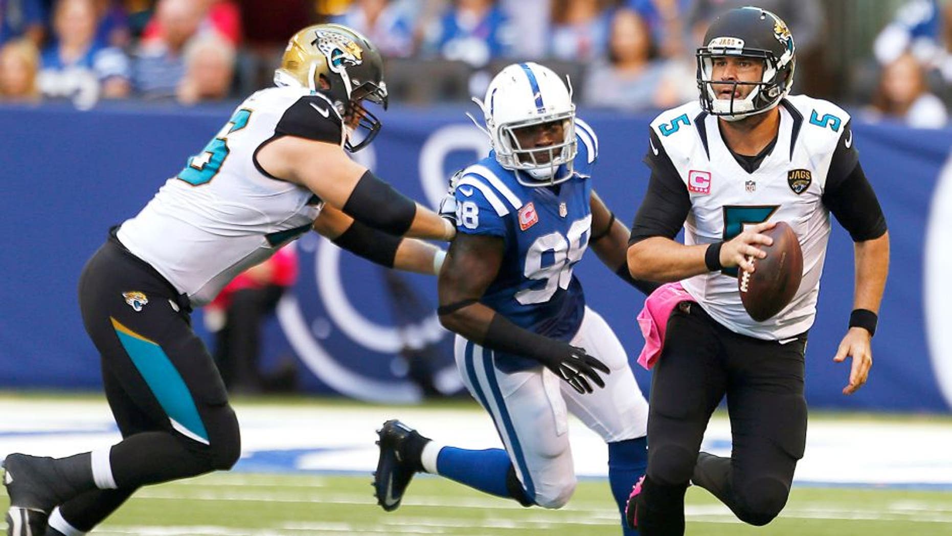Oct 4, 2015; Indianapolis, IN, USA; Jacksonville Jaguars quarterback Blake Bortles (5) runs away from Indianapolis Colts linebacker Robert Mathis (98) at Lucas Oil Stadium. Indianapolis defeats Jacksonville 16-13 in overtime. Mandatory Credit: Brian Spurlock-USA TODAY Sports