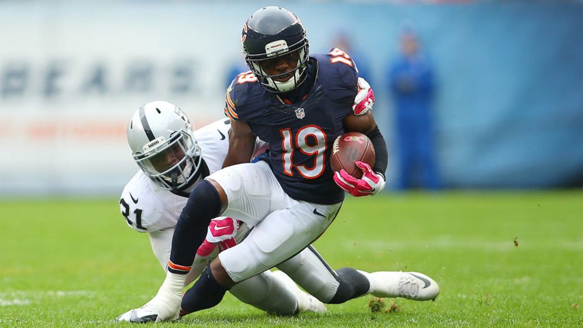 Oct 4, 2015; Chicago, IL, USA; Chicago Bears wide receiver Eddie Royal (19) is tackled by Oakland Raiders cornerback Neiko Thorpe (31) during the second half at Soldier Field. Mandatory Credit: Jerry Lai-USA TODAY Sports
