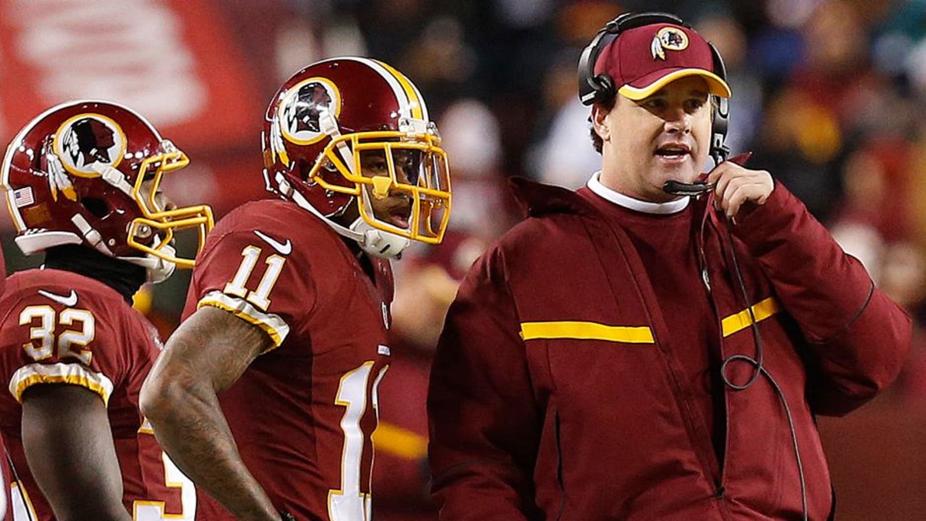 Dec 20, 2014; Landover, MD, USA; Washington Redskins head coach Jay Gruden (R) talks to Redskins wide receiver DeSean Jackson (11) on the sidelines against the Philadelphia Eagles in the fourth quarter at FedEx Field. The Redskins won 27-24. Mandatory Credit: Geoff Burke-USA TODAY Sports