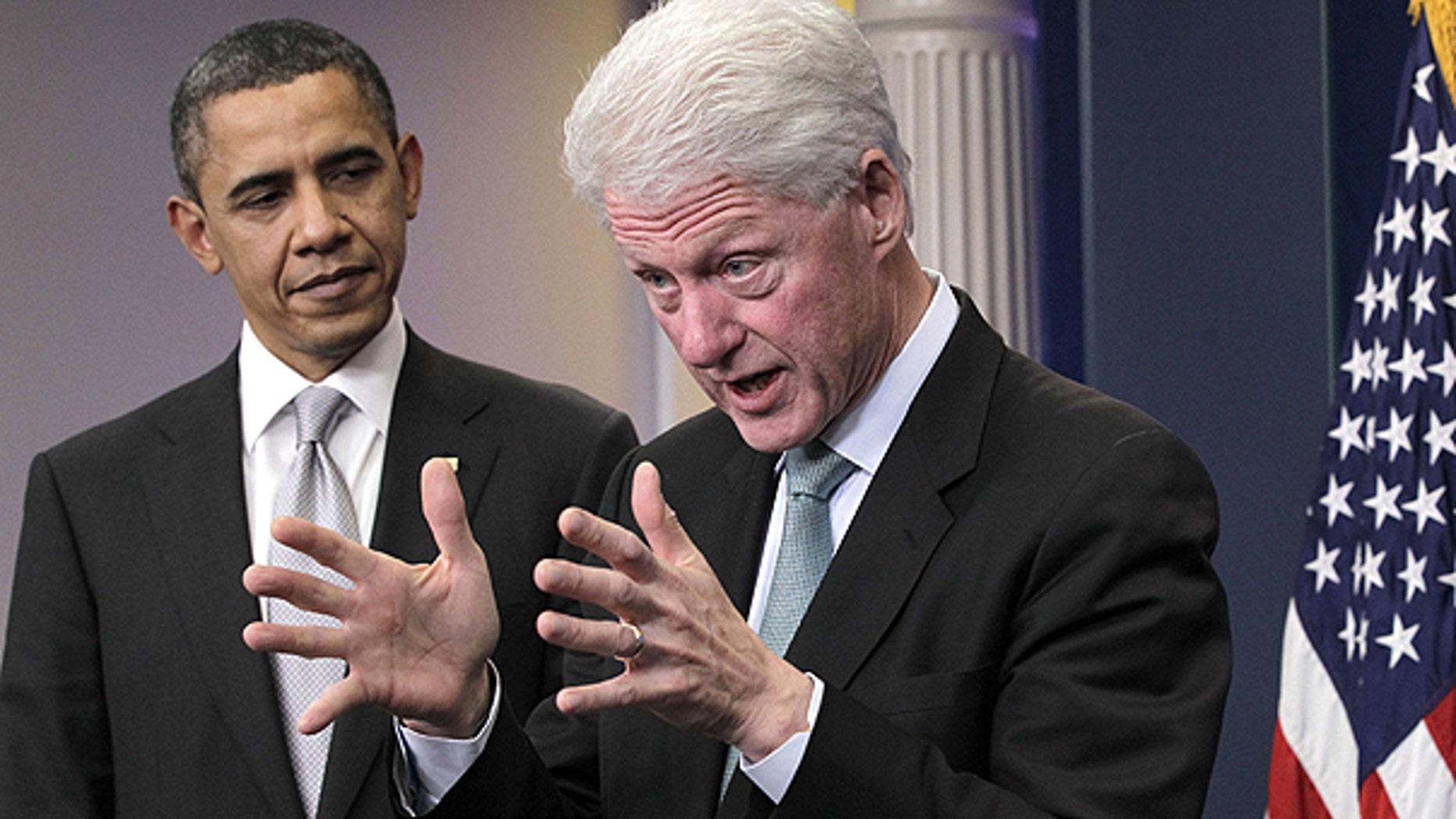 Dec. 10: President Obama looks on as former President Bill Clinton speaks in the briefing room of the White House in Washington.