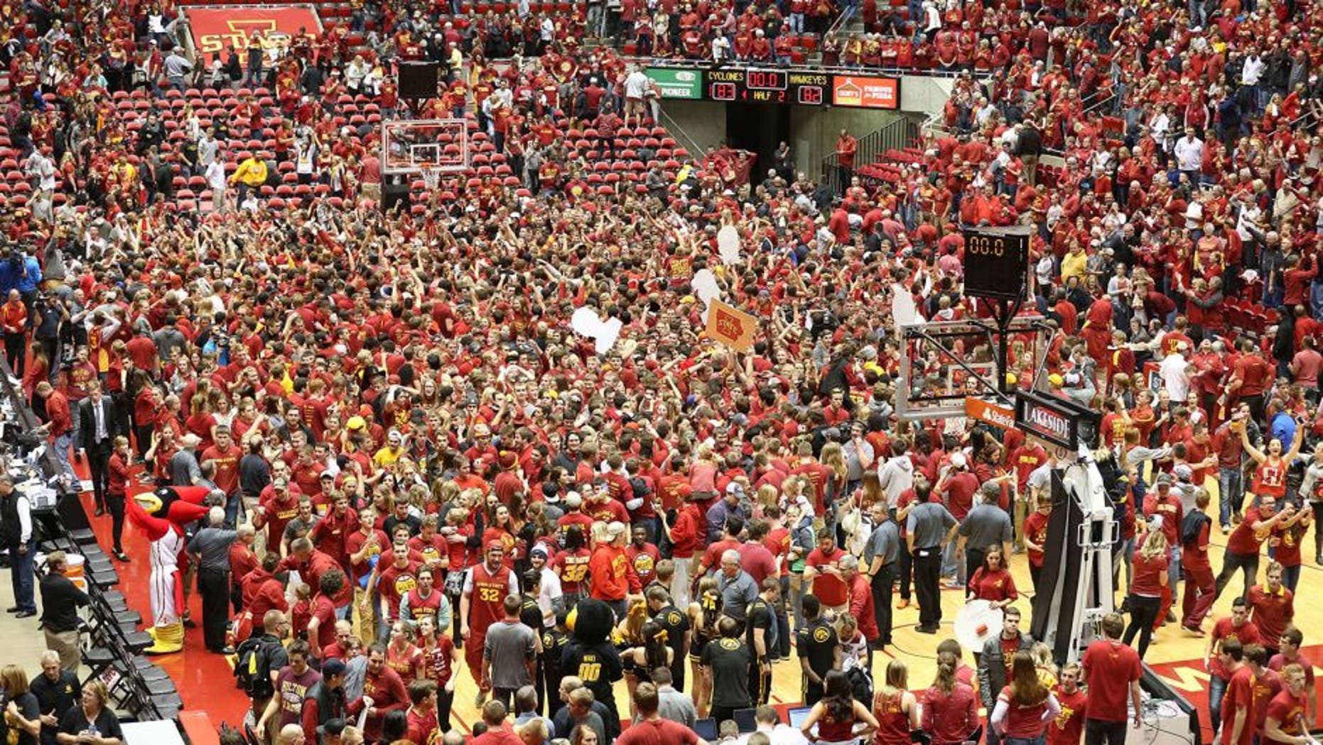 Dec 10, 2015; Ames, IA, USA; Iowa State Cyclones students rush the court after beating the Iowa Hawkeyes at James H. Hilton Coliseum. The Cyclones beat the Hawkeyes 83-82. Mandatory Credit: Reese Strickland-USA TODAY Sports