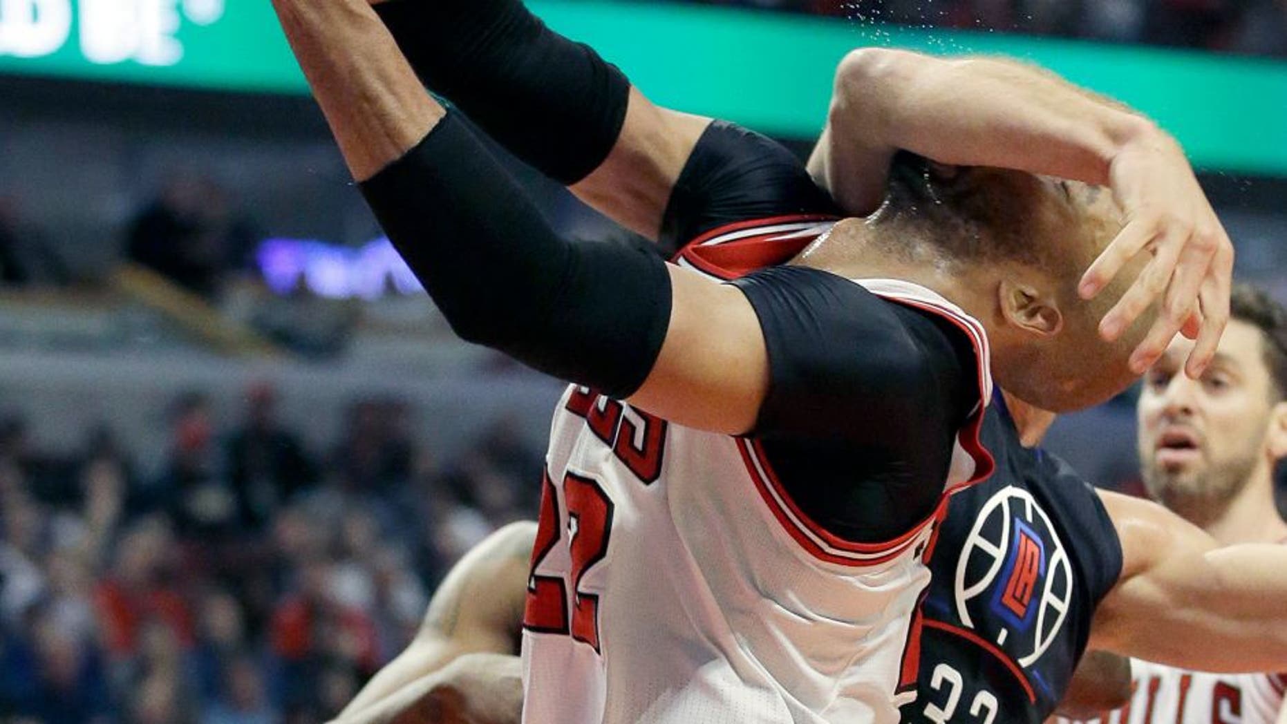 Los Angeles Clippers forward Blake Griffin (32) fouls Chicago Bulls forward Taj Gibson during the second half of an NBA basketball game on Thursday, Dec. 10, 2015, in Chicago. (AP Photo/Nam Y. Huh)