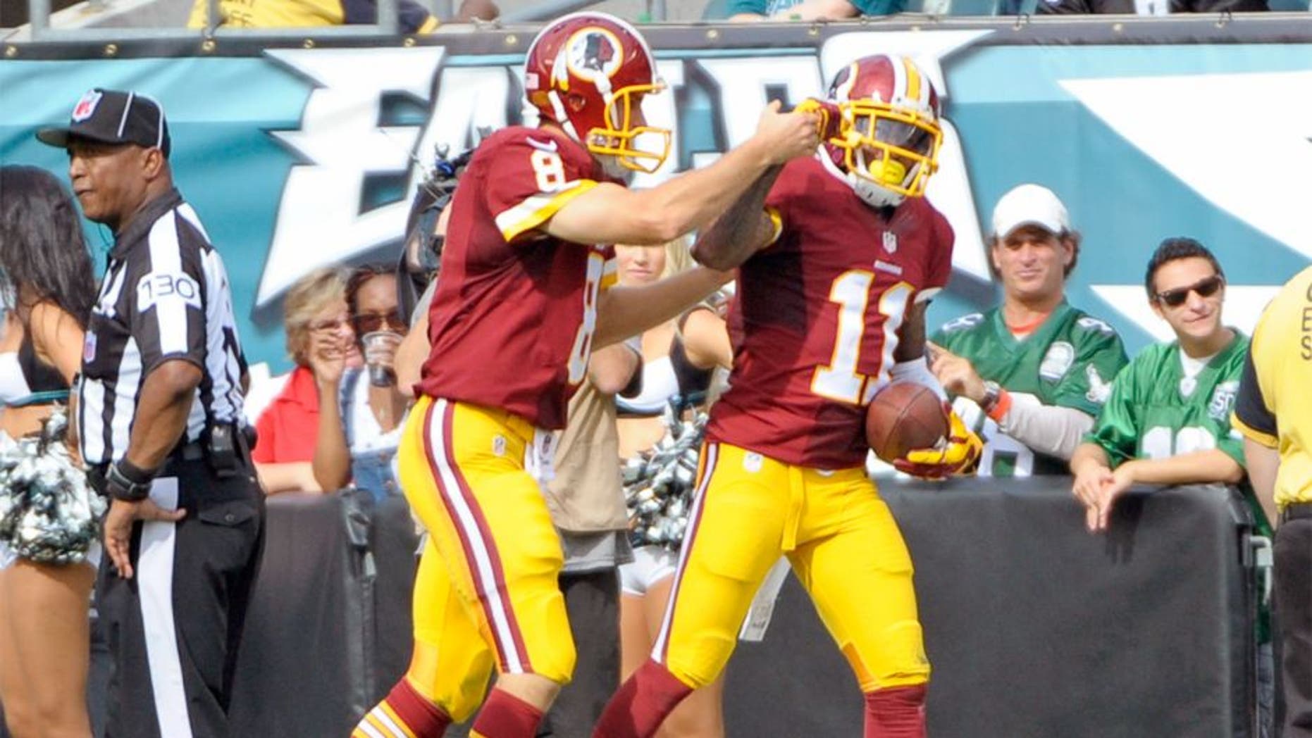 Sep 21, 2014; Philadelphia, PA, USA; Washington Redskins quarterback Kirk Cousins (8) and wide receiver DeSean Jackson (11) celebrate 81-yard touchdown catch in the third quarter against the Philadelphia Eagles at Lincoln Financial Field. The Eagles defeated the Redskins, 37-34. Mandatory Credit: Eric Hartline-USA TODAY Sports