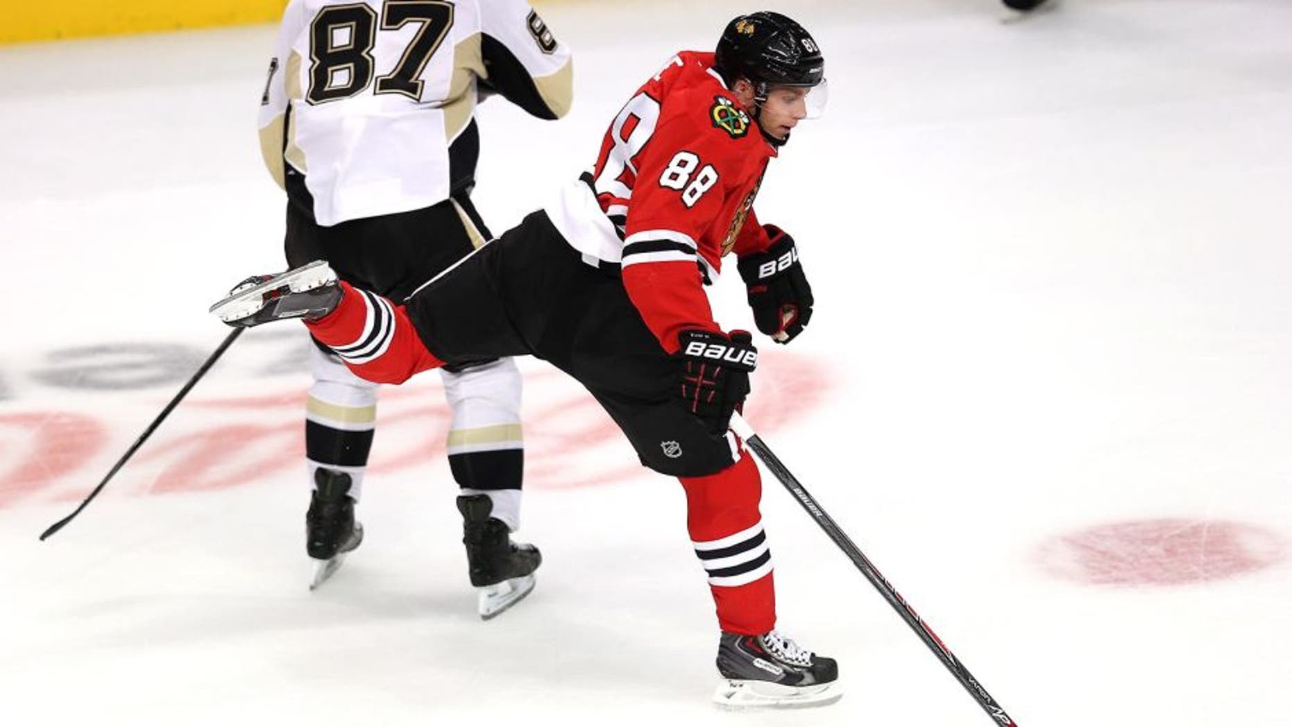 CHICAGO, IL - SEPTEMBER 19: Patrick Kane #88 of the Chicago Blackhawks leaps to avoid colliding with Sidney Crosby #87 of the Pittsburgh Penguins during an exhibition game at United Center on September 19, 2013 in Chicago, Illinois. The Penguins defeated the Blackhawks 4-3 in a shootout. (Photo by Jonathan Daniel/Getty Images)