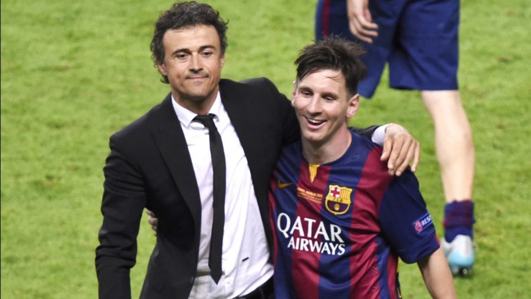 Barcelona's coach Luis Enrique (L) and Barcelona's Argentinian forward Lionel Messi celebrate after the UEFA Champions League Final football match between Juventus and FC Barcelona at the Olympic Stadium in Berlin on June 6, 2015. FC Barcelona won the match 1-3. AFP PHOTO / ODD ANDERSEN (Photo credit should read ODD ANDERSEN/AFP/Getty Images)