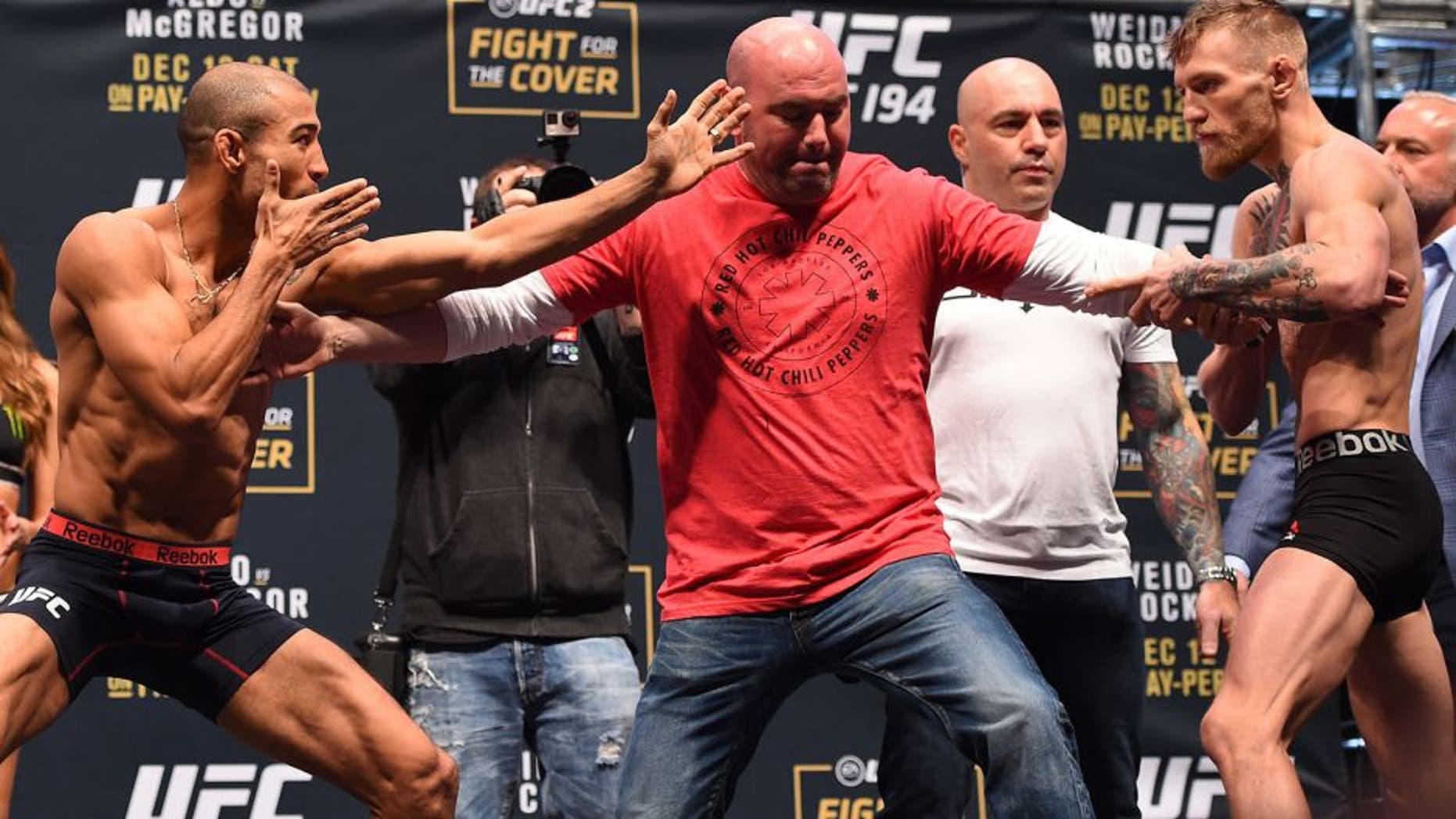 LAS VEGAS, NV - DECEMBER 11: (L-R) UFC featherweight champion Jose Aldo of Brazil and interim UFC featherweight champion Conor McGregor of Ireland face off during the UFC 194 weigh-in inside MGM Grand Garden Arena on December 10, 2015 in Las Vegas, Nevada. (Photo by Josh Hedges/Zuffa LLC/Zuffa LLC via Getty Images)