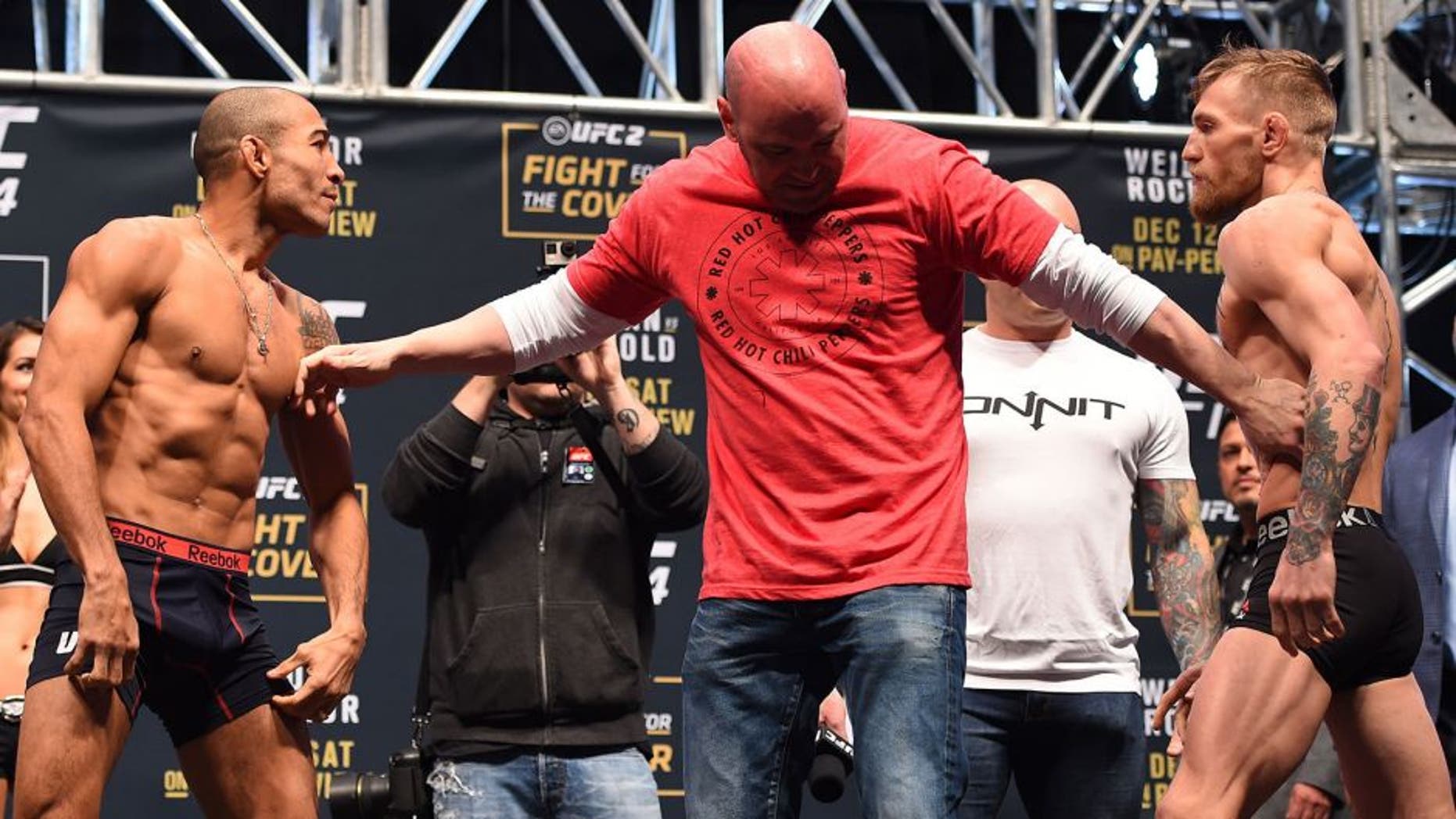 LAS VEGAS, NV - DECEMBER 11: (L-R) UFC featherweight champion Jose Aldo of Brazil and interim UFC featherweight champion Conor McGregor of Ireland face off during the UFC 194 weigh-in inside MGM Grand Garden Arena on December 10, 2015 in Las Vegas, Nevada. (Photo by Josh Hedges/Zuffa LLC/Zuffa LLC via Getty Images)