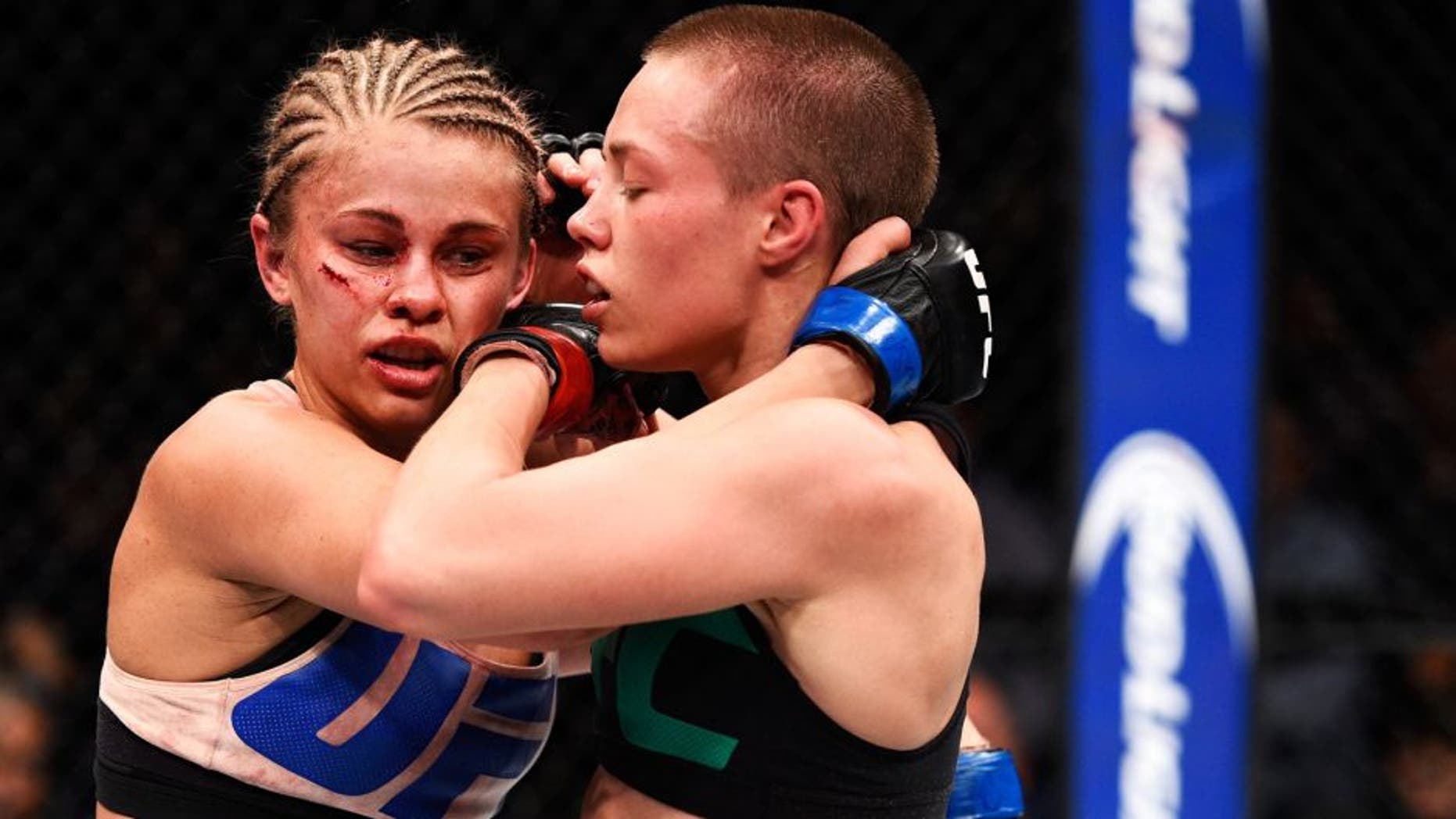 LAS VEGAS, NEVADA - DECEMBER 10: (R) Rose Namajunas clinches with Paige VanZant in their women's strawweight bout during the UFC Fight Night event at The Chelsea at the Cosmopolitan of Las Vegas on December 10, 2015 in Las Vegas, Nevada. (Photo by Jeff Bottari/Zuffa LLC/Zuffa LLC via Getty Images)