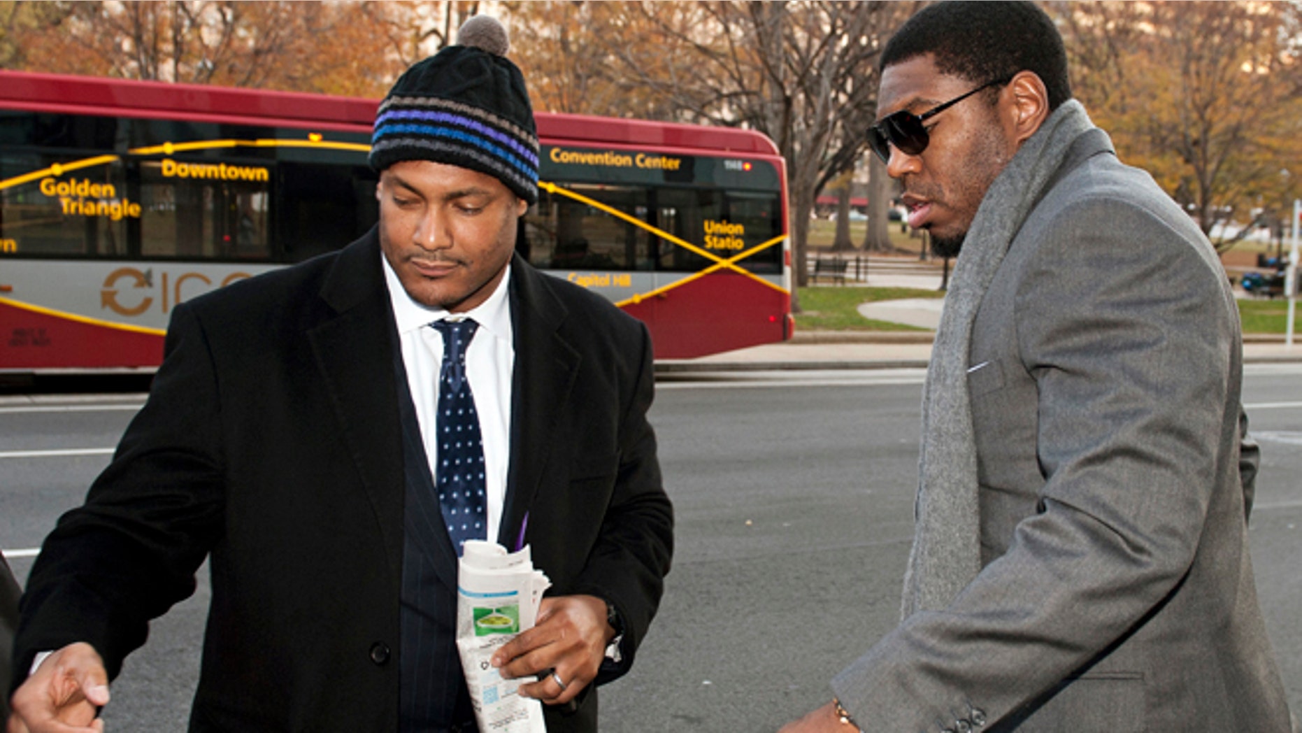 FILE - In this Nov. 30, 2012, file photo, New Orleans Saints football defensive end Will Smith, left, and linebacker Jonathan Vilma arrive at an attorney's office in Washington, for a hearing on their appeals of bounties suspensions.