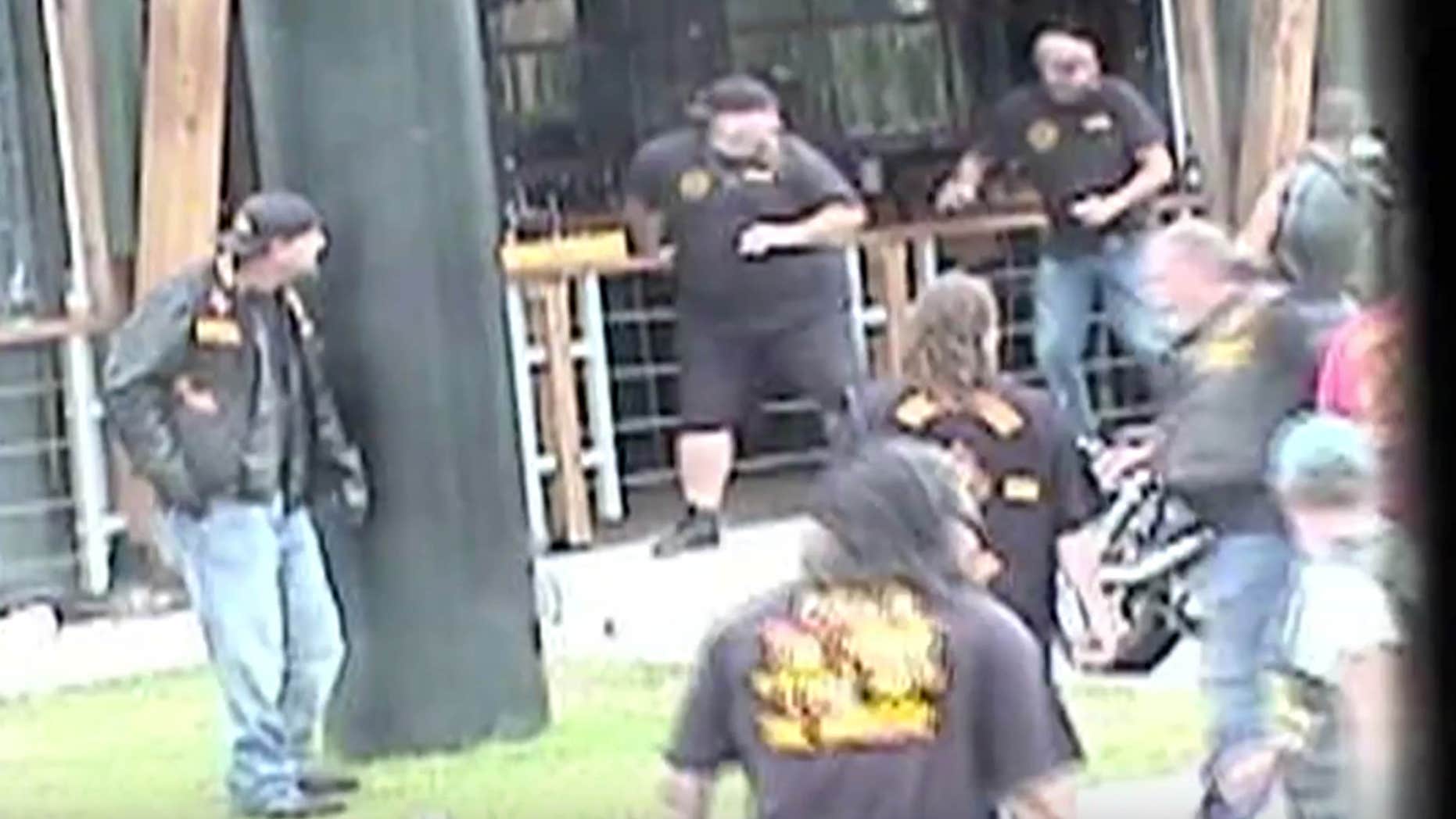 May 17, 2015: In this image made from Texas Department of Public Safety video, bikers run for cover as a shooting erupts outside a Twin Peaks restaurant in Waco, Texas.