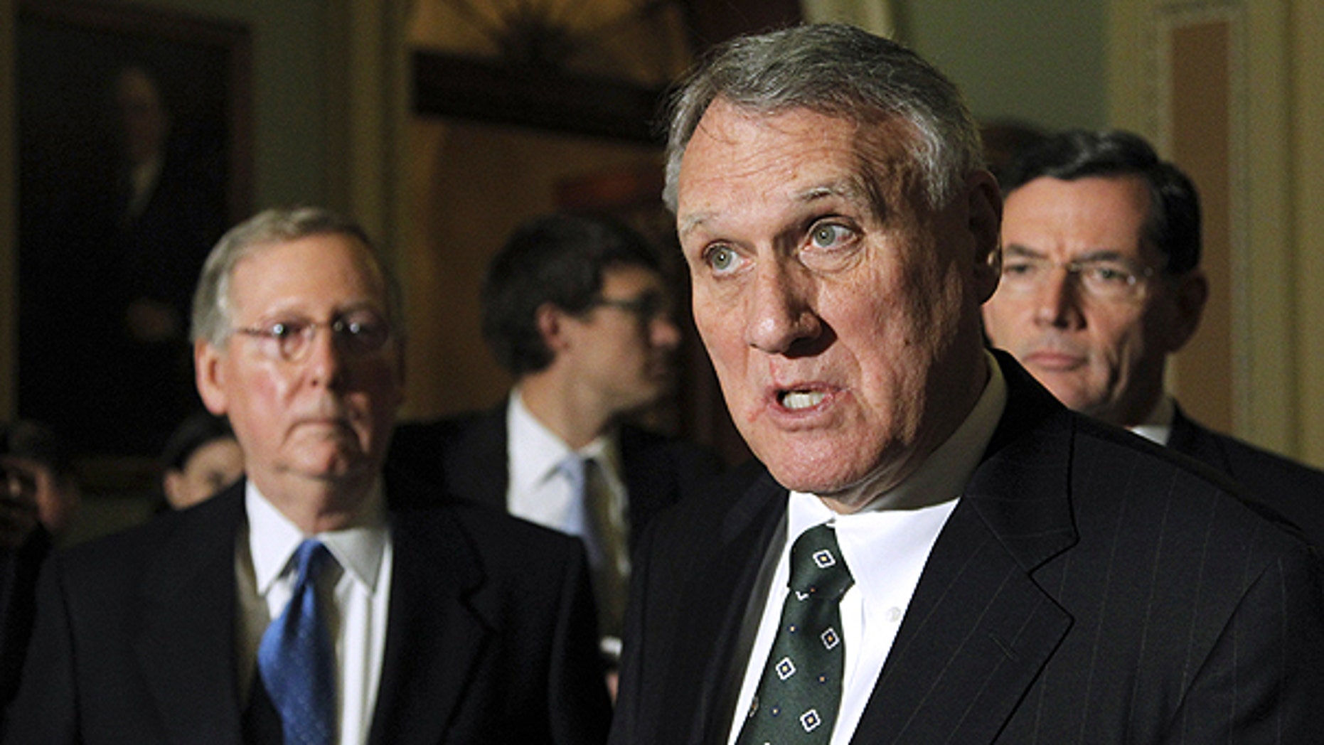 Nov. 30: Senate Minority Whip Jon Kyl of Ariz., center, accompanied by Senate Minority Leader Sen. Mitch McConnell of Ky., left, and Sen. John Barrasso, R-Wyo., speaks to reporters during a news conference on Capitol Hill in Washington.