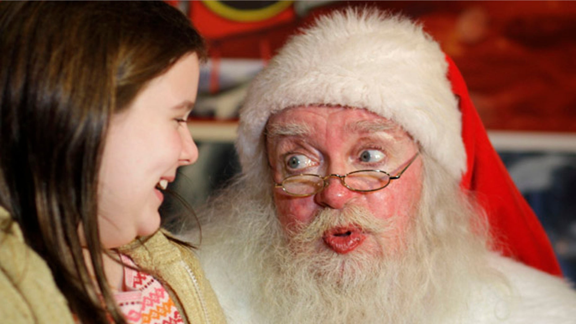 John Toomey, the naughty Santa Claus who was fired from Macy's, visits with nine-year-old Retta Campbell of Sebastopol, Calif., on the first day of his new job in San Francisco, Friday, Dec. 10, 2010. Toomey lost his 20-year job playing St. Nick at the Macy's downtown San Francisco store last weekend after an adult couple complained about a joke he made. He has since taken up a position playing Santa at Lefty O'Doul's, a nearby pub. Earlier this week he was on Jay Leno's "Tonight Show." (AP Photo/Eric Risberg)