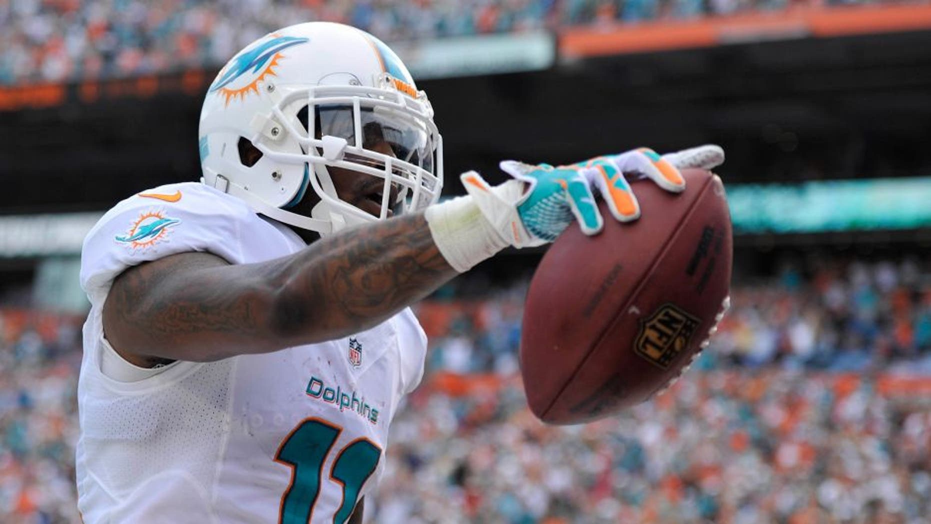 Dec 15, 2013; Miami Gardens, FL, USA; Miami Dolphins wide receiver Mike Wallace (11) celebrates his touchdown against the New England Patriots in the first half of the game at Sun Life Stadium. Mandatory Credit: Brad Barr-USA TODAY Sports