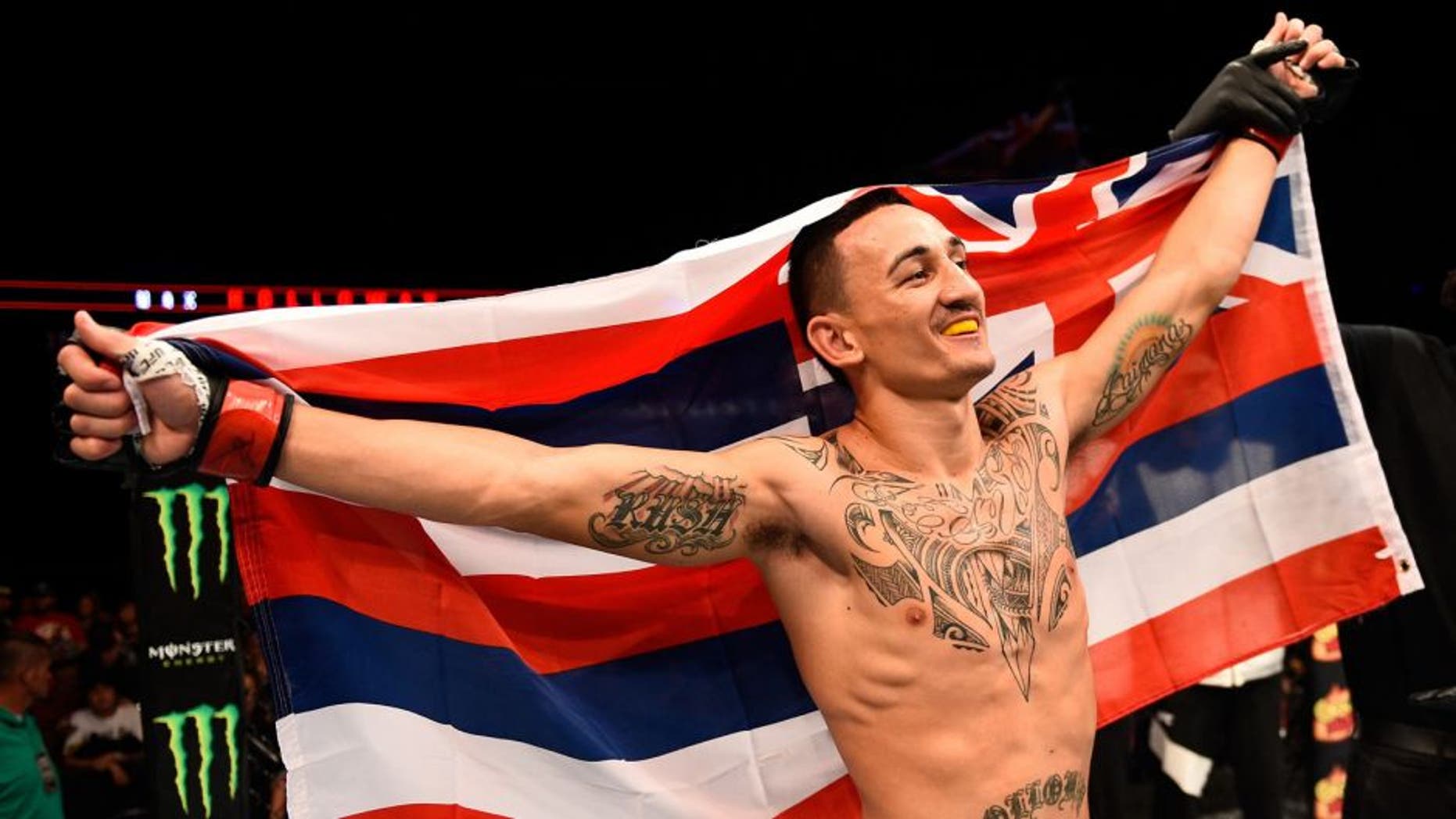 SASKATOON, SK - AUGUST 23: Max Holloway of the United States celebrates after his victory over Charles Oliveira in their featherweight bout during the UFC event at the SaskTel Centre on August 23, 2015 in Saskatoon, Saskatchewan, Canada. (Photo by Jeff Bottari/Zuffa LLC/Zuffa LLC via Getty Images)